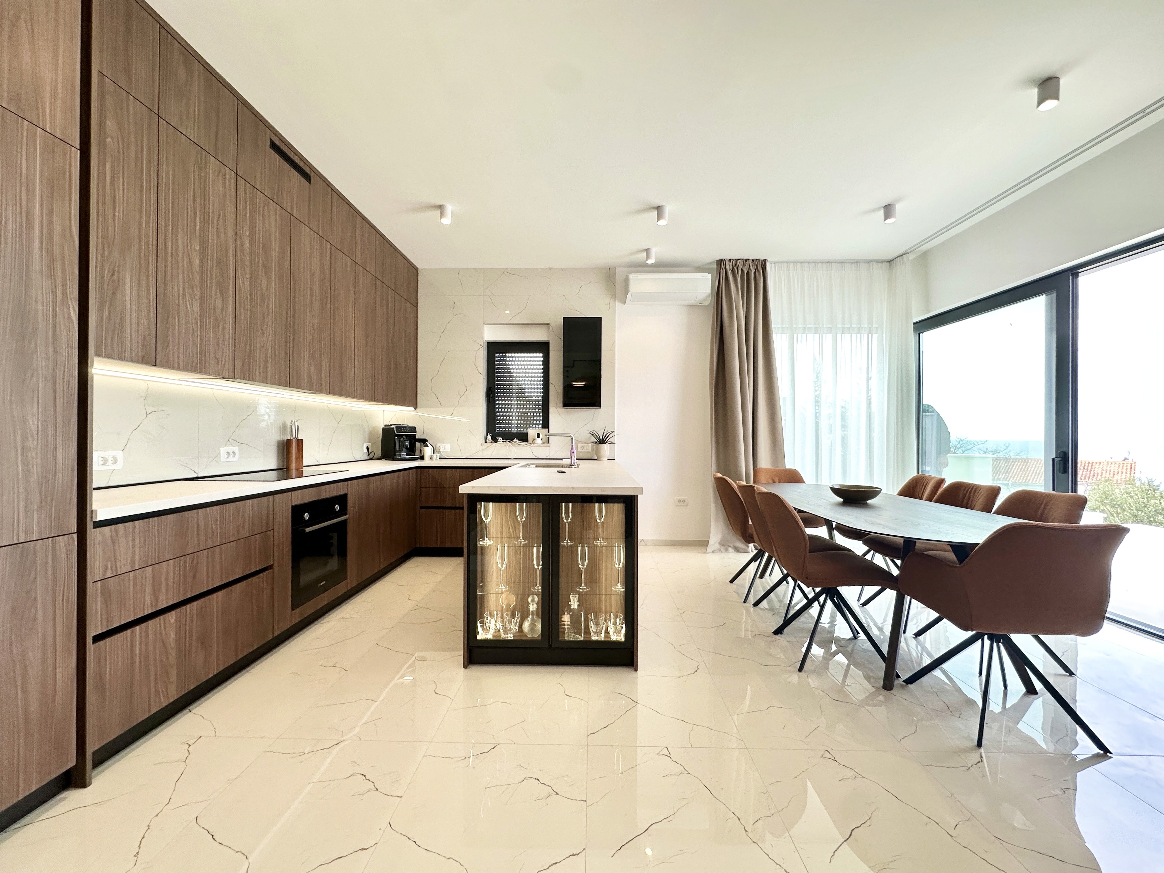 Industrial bathroom with concrete walls and wooden vanity with plants.