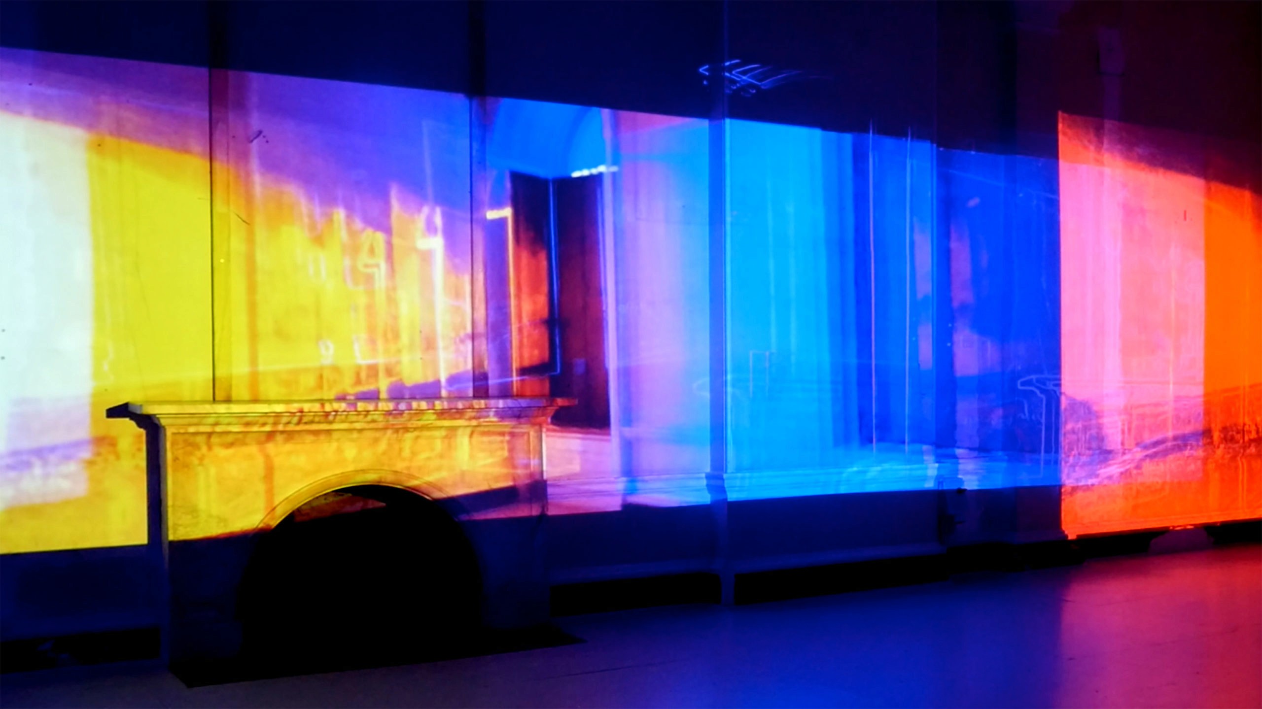 projection of an interior with a fireplace covered in the colors of the spectrum