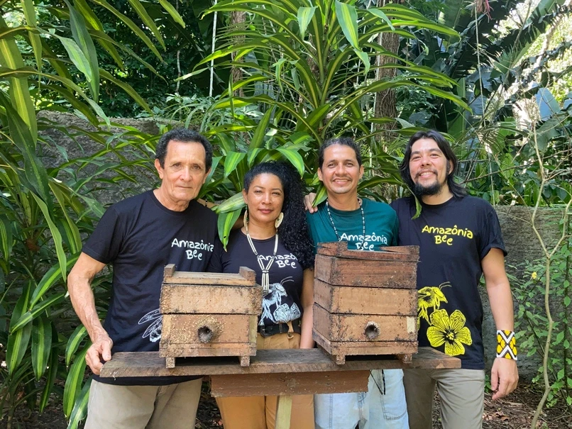 Retrato dos 4 membros da equipe Amazônia Bee em fundo de natureza.