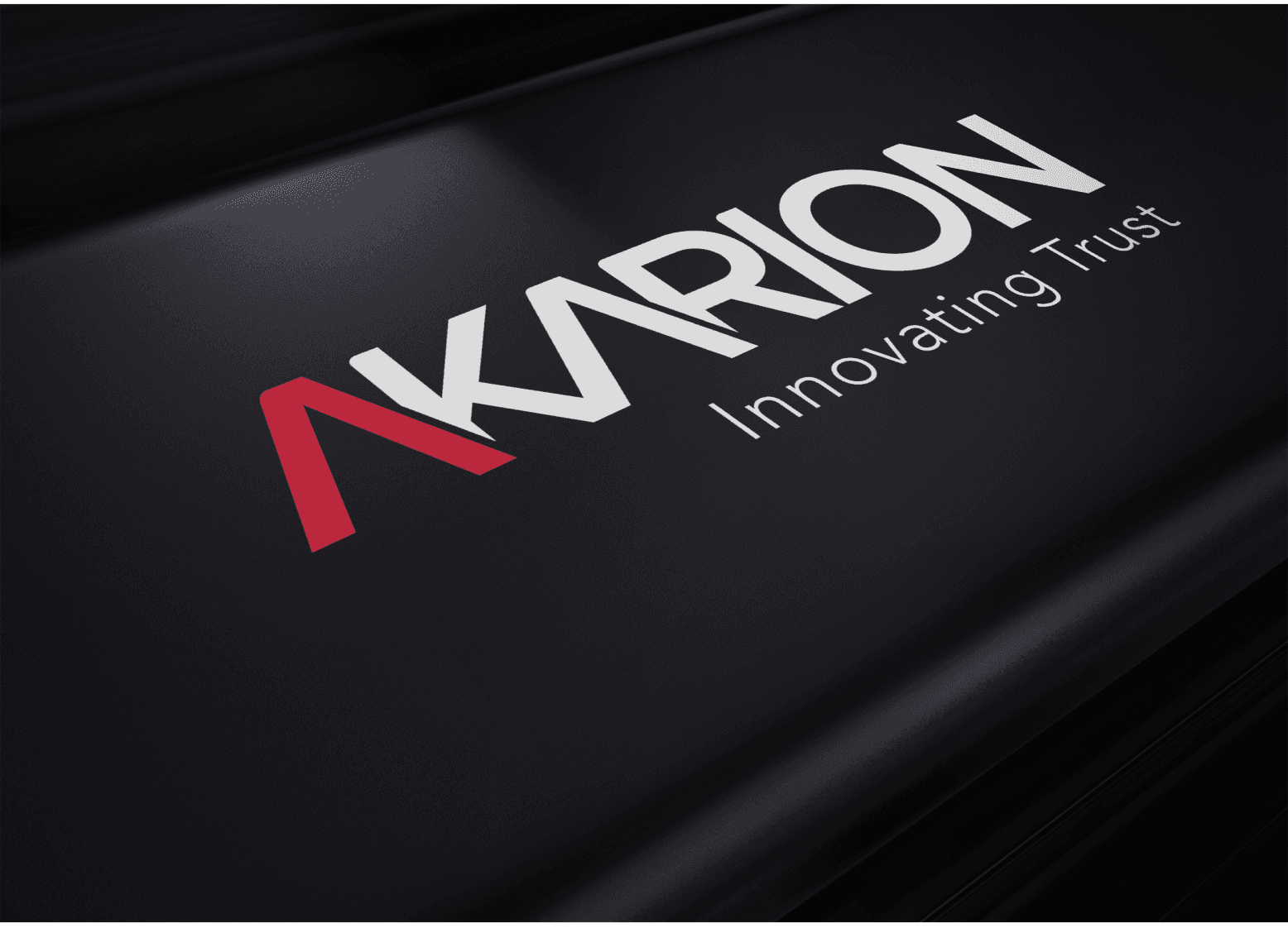 Detail show of logo embossed on a black surface.