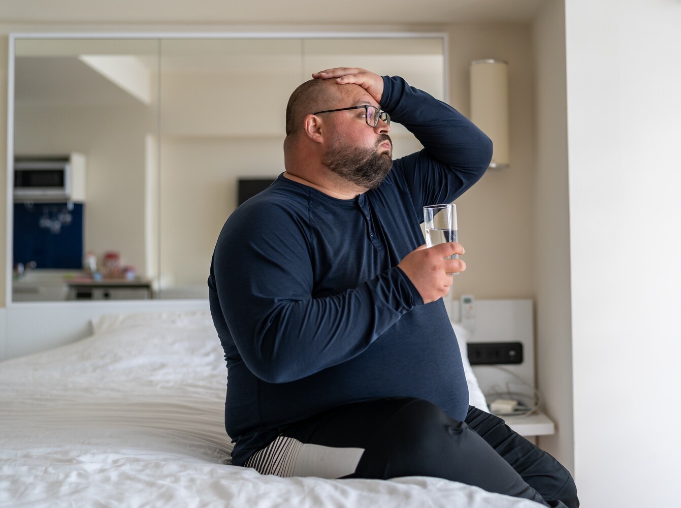 overweight man feeling unwell because of side effects from pills that help lose weight