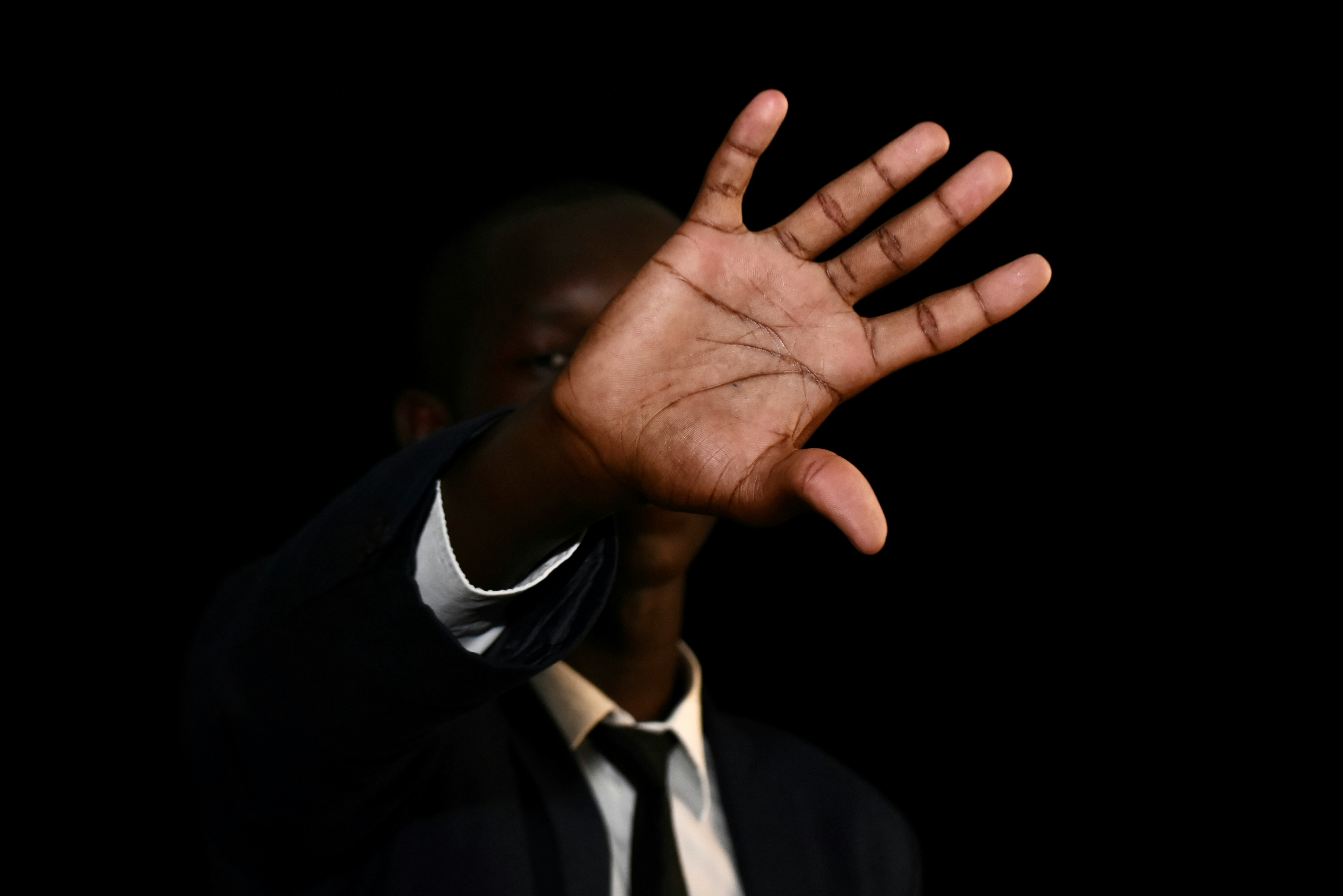 a man holding his hand up