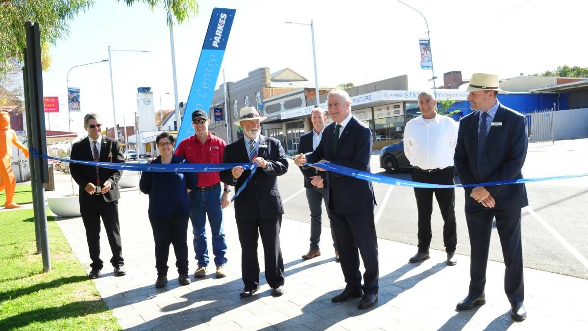 Ribbon cutting ceremony for a completed Uminex main street renewal project, featuring council representatives, project stakeholders, and upgraded public infrastructure in an active town centre.