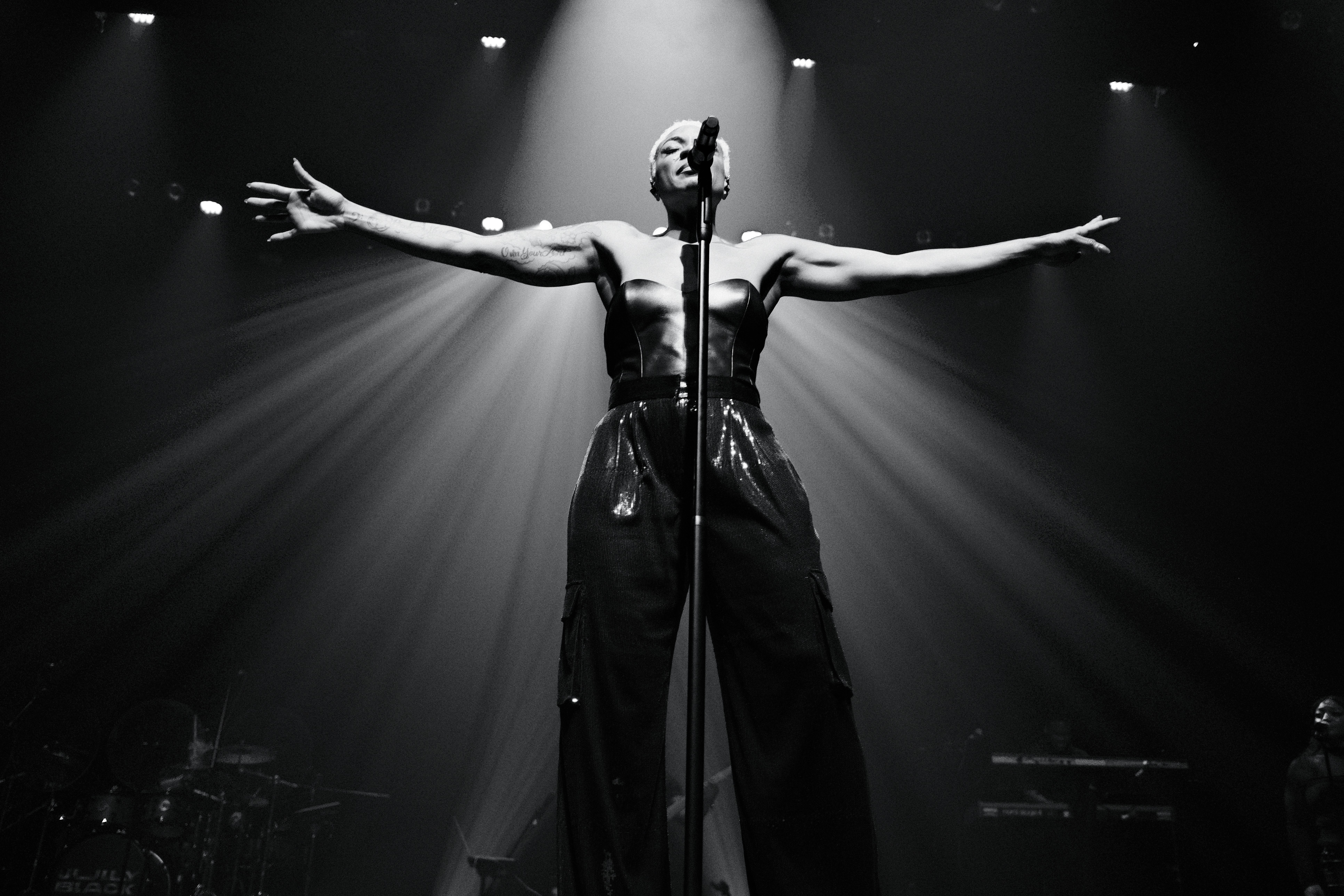Man wearing sunglasses and headscarf in low light