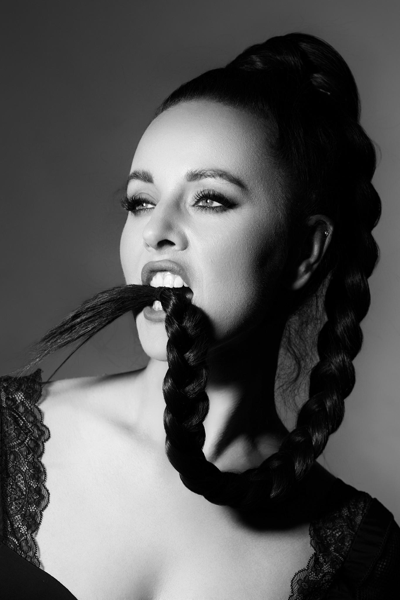 Woman holding a braid between her teeth, tension and control - Braid - Agnieszka Czyzkowska Photography