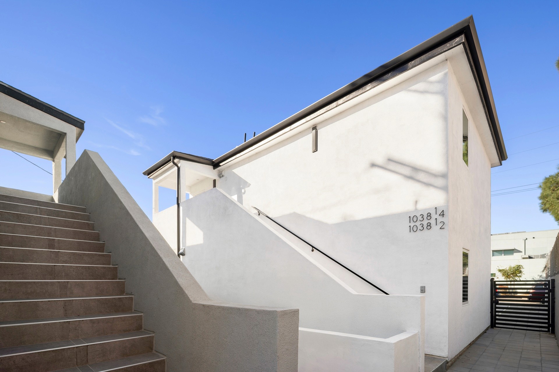 Exterior stair access and modern white building facade with clean architectural lines at 1038 E 53rd