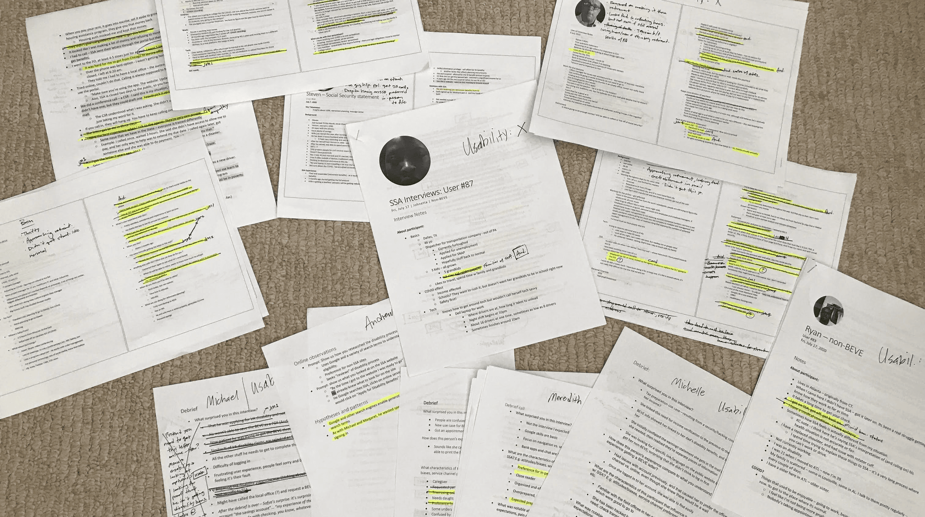 Printouts of user interviews with handwritten notes and highlights.