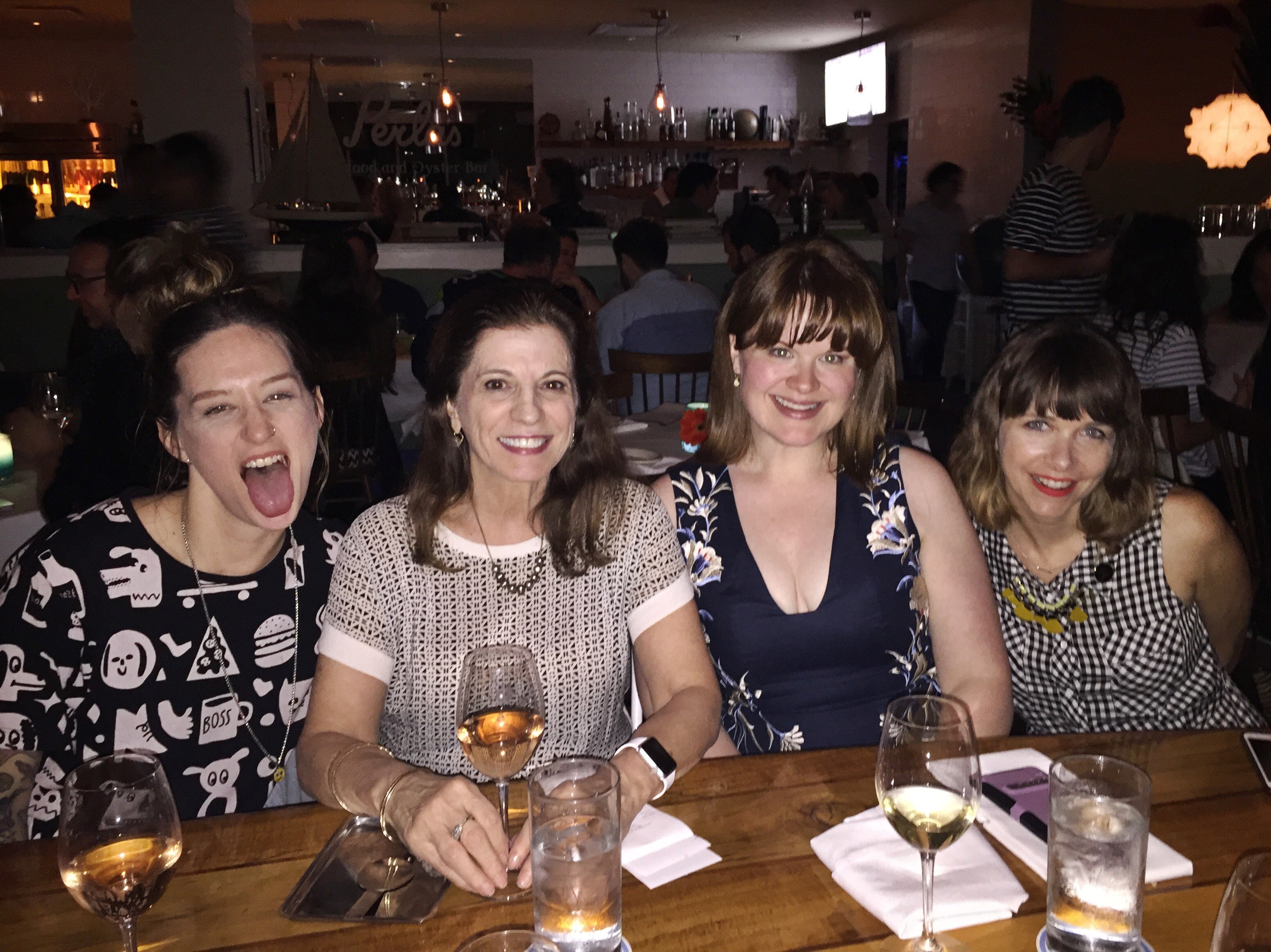 group photo of four woman having a drink