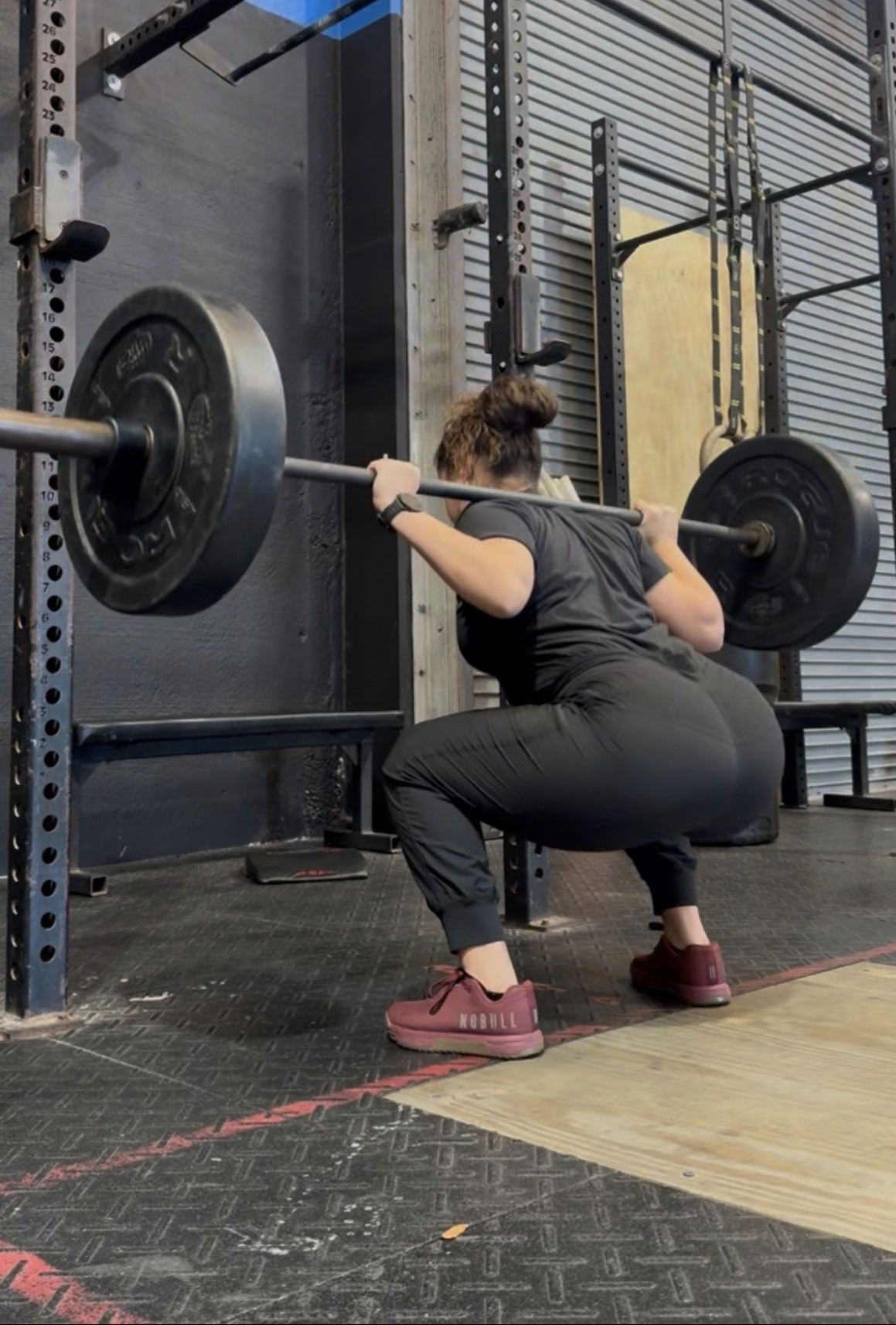 Female performing a heavy back squat