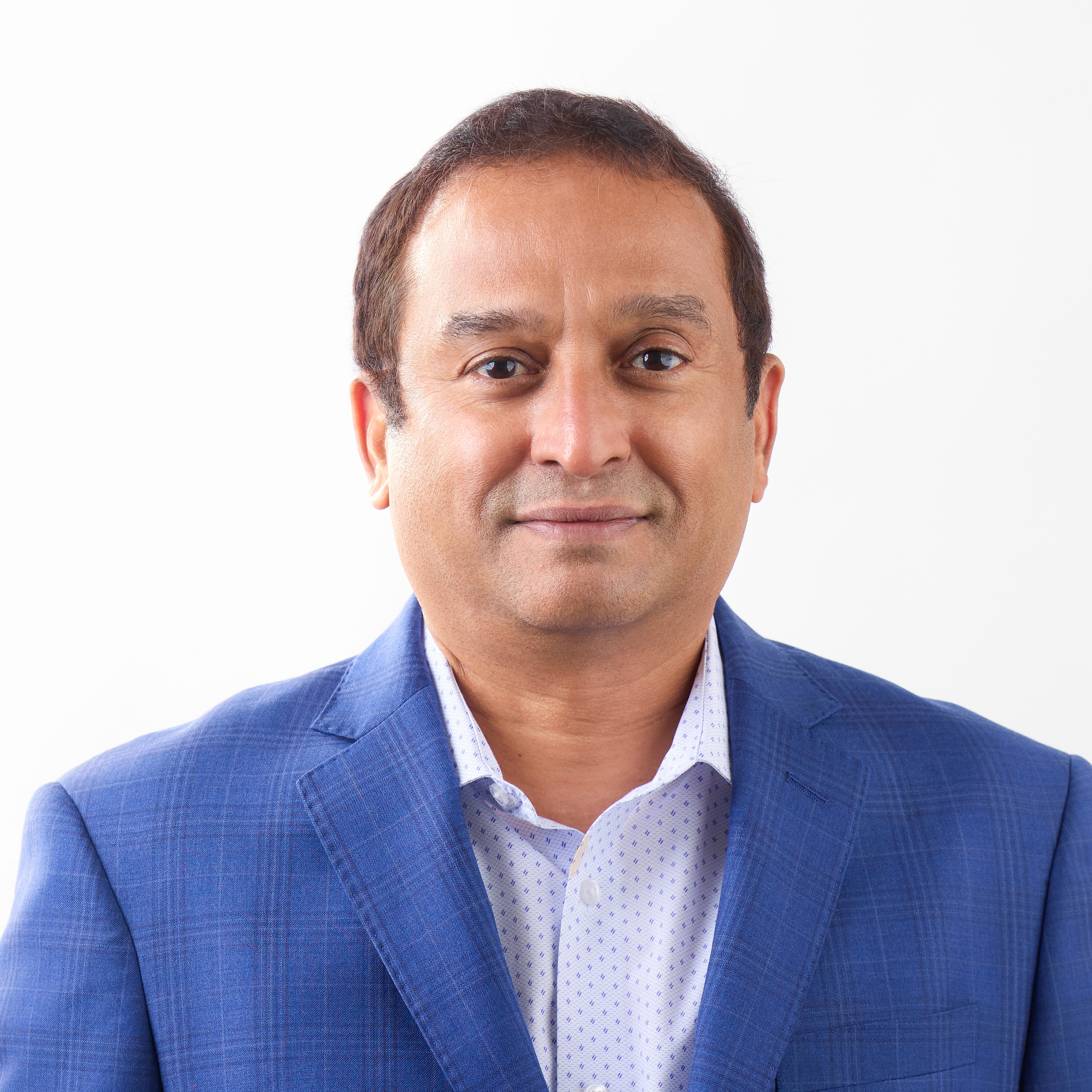 woman in brown long-sleeved top standing beside wall