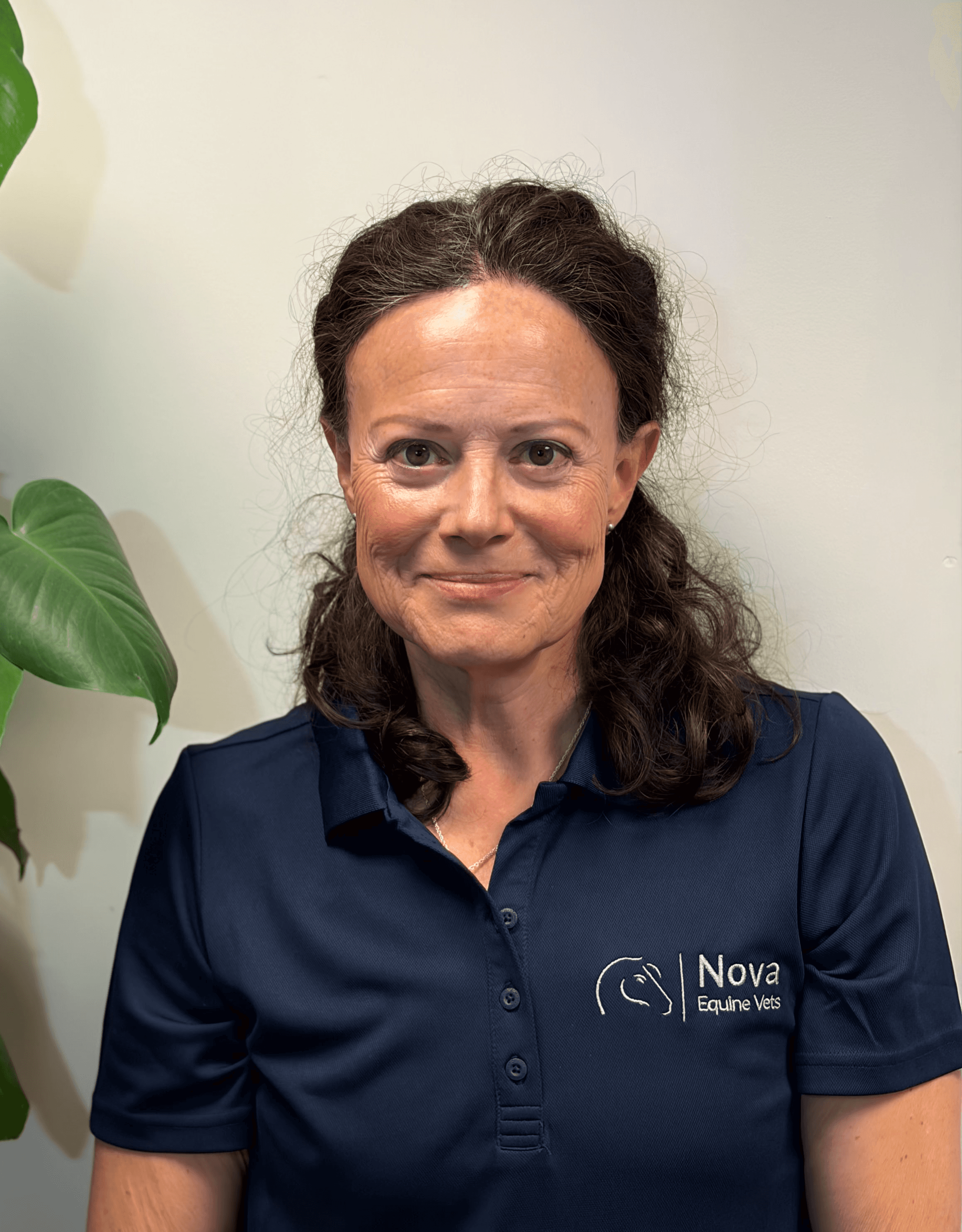 a man in a blue shirt smiling at the camera