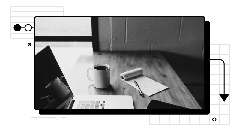 Photo of a desk with a laptop, notepad and a cup of coffee on top of it.