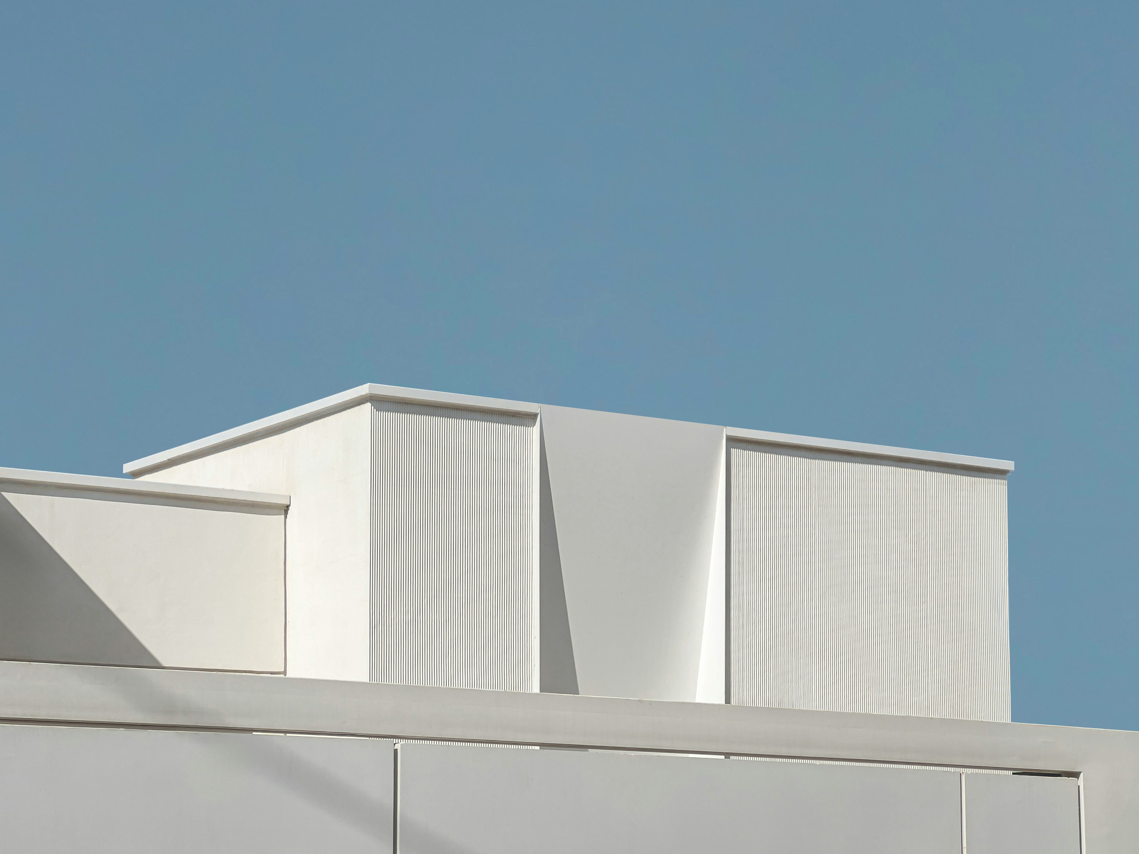 a clock on the side of a white building