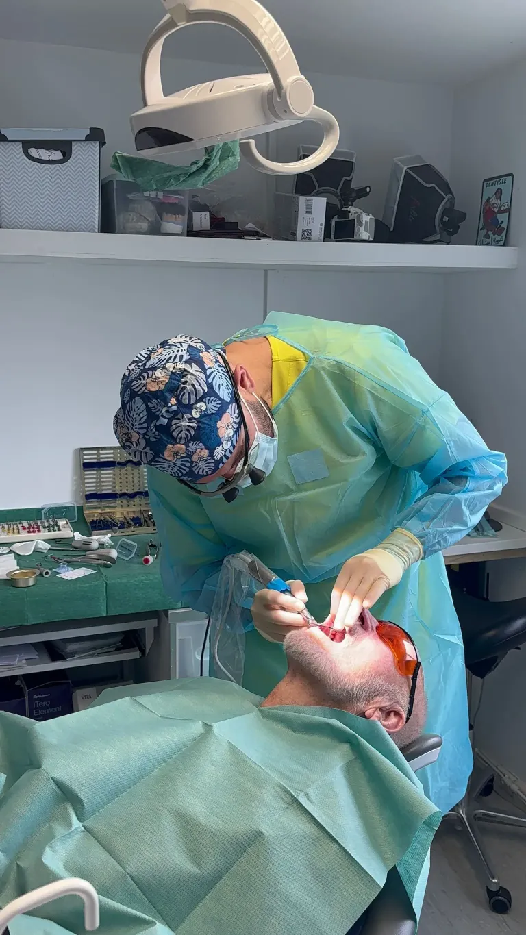 Dr Muataz in surgery doing some gum treatment or periodontal work on a patient.
