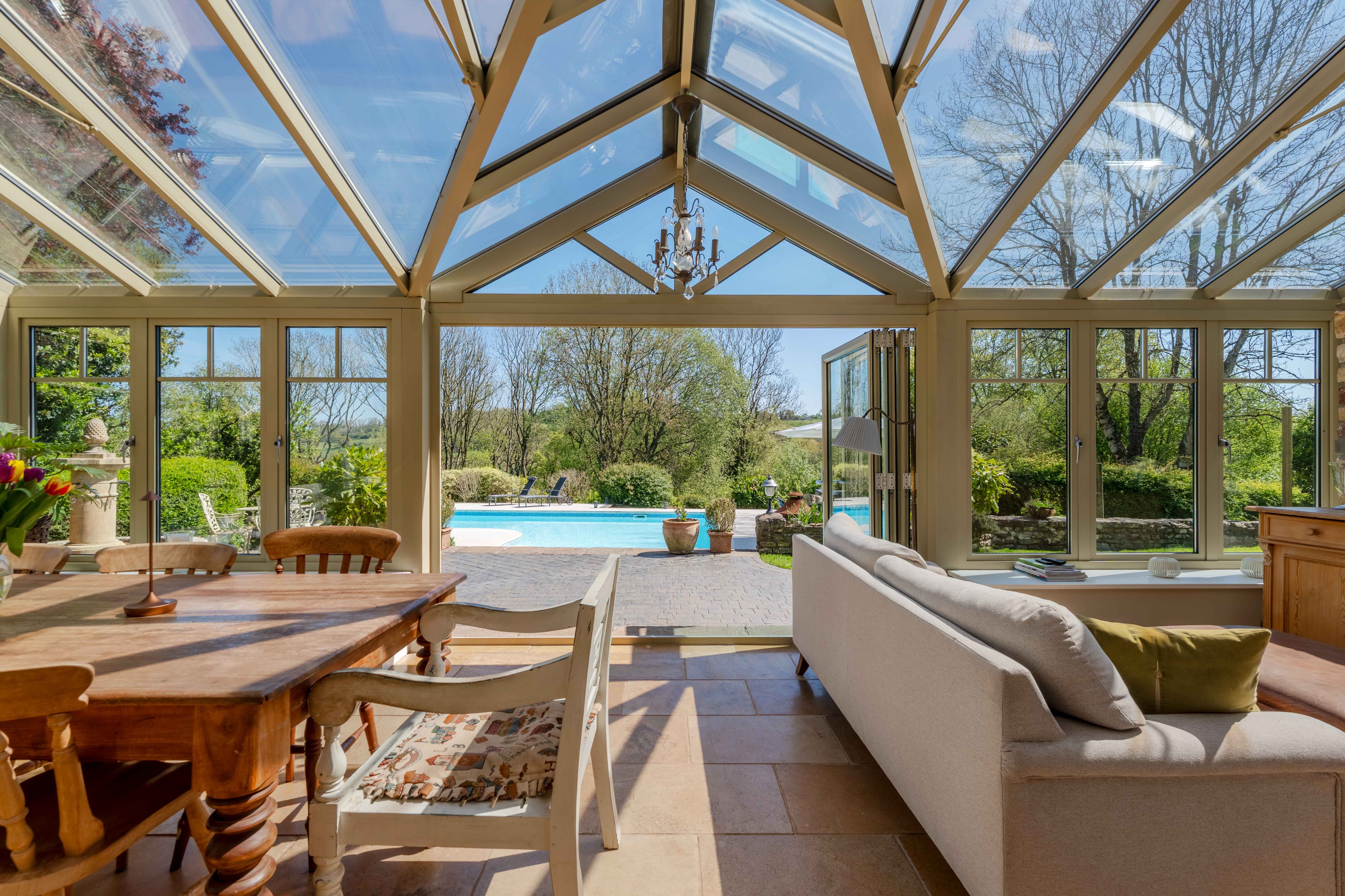 open-plan kitchen with island and bi-fold doors to patioman