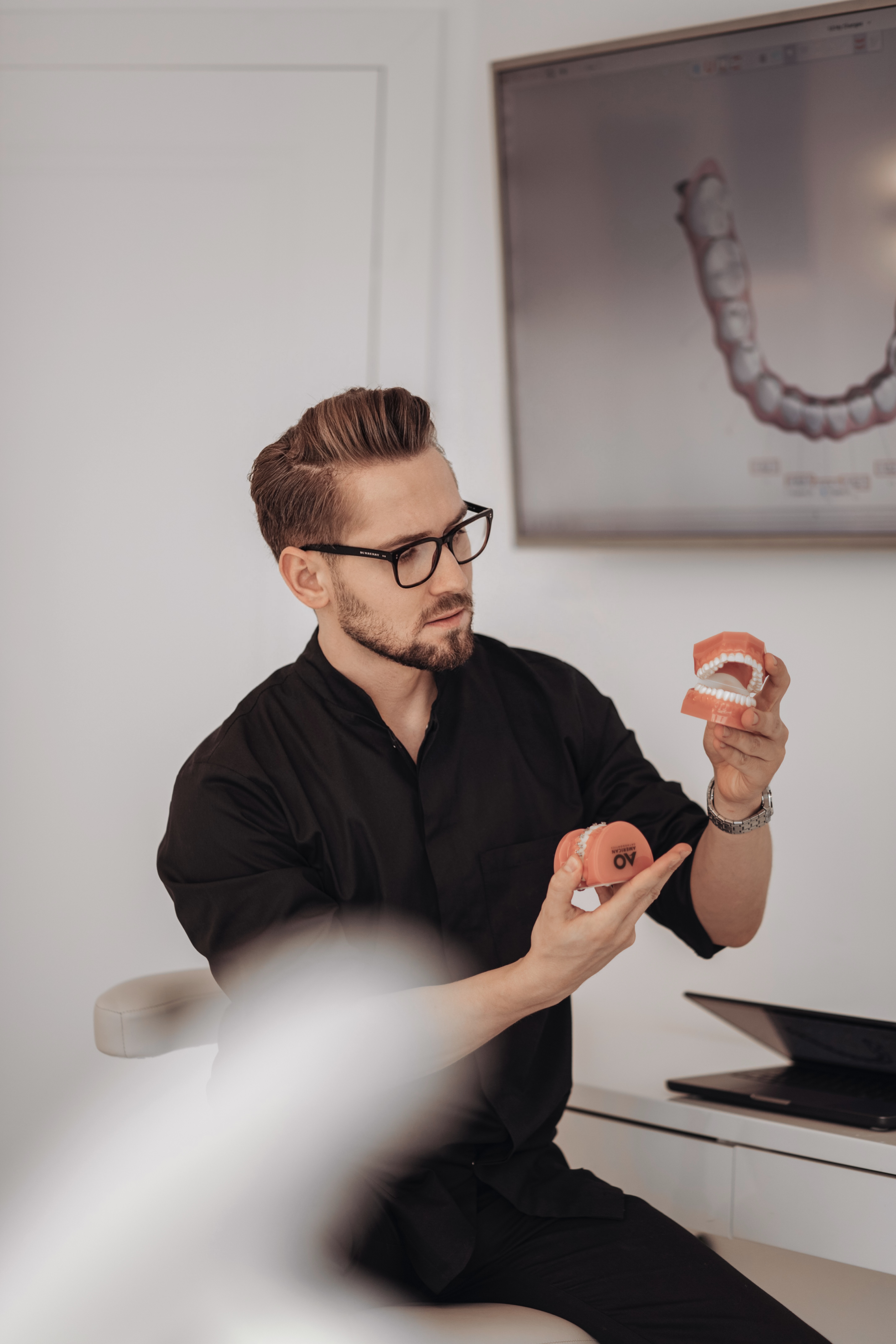 a man in a dentist's office holding a pair of scissors