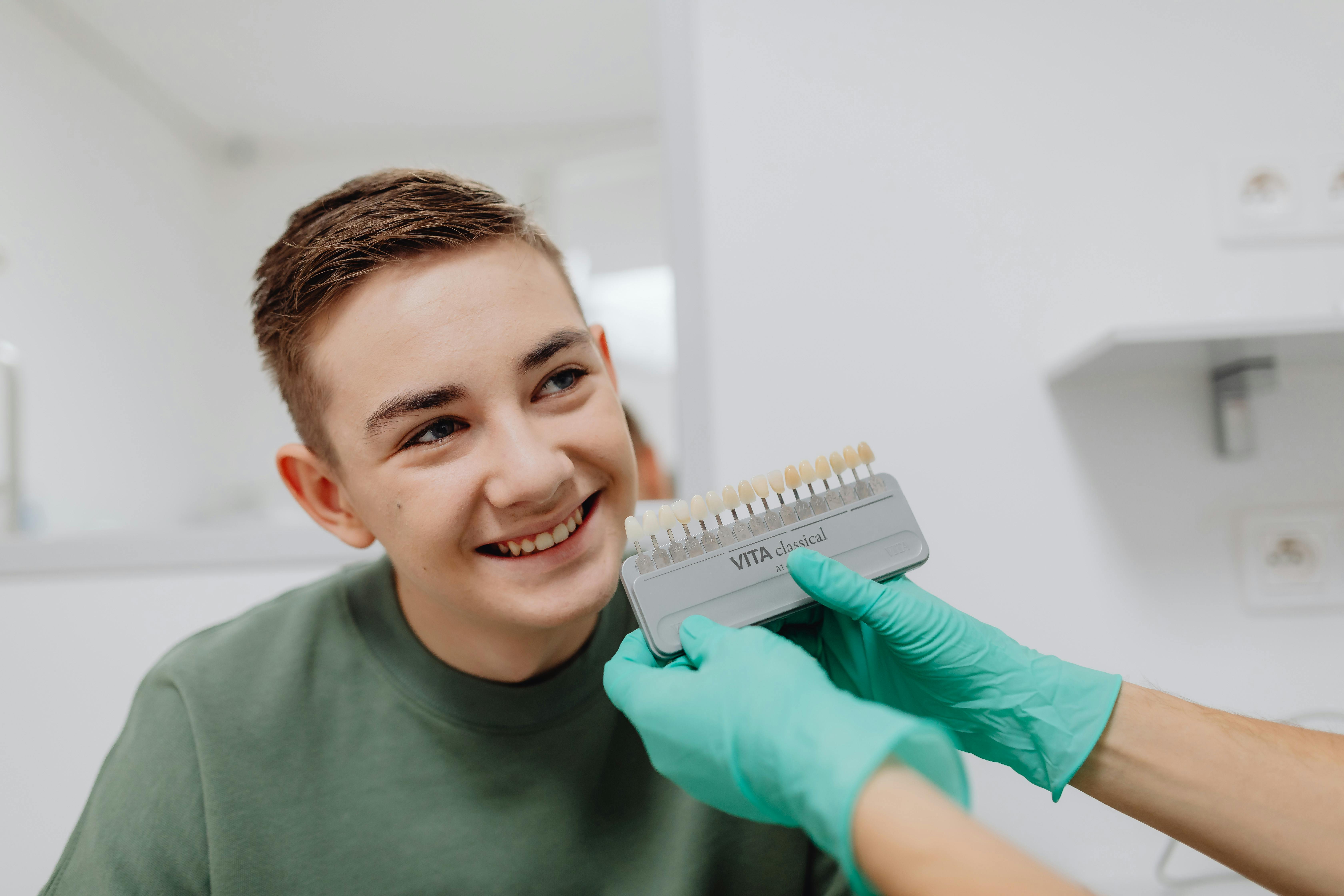 Young male dental patient finding tooth color match