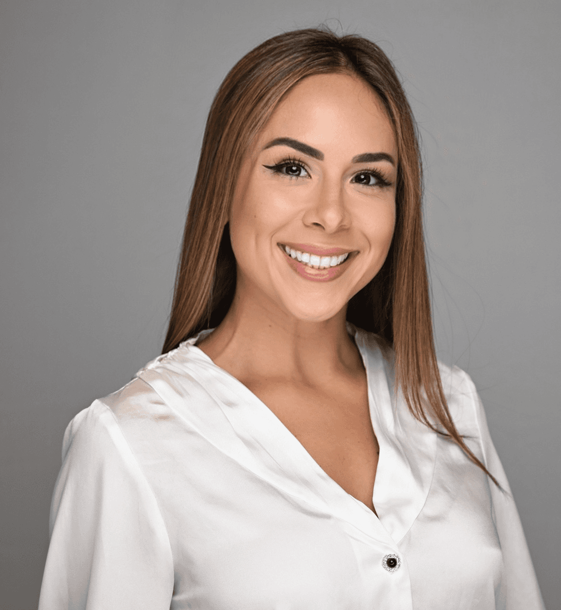 woman staring directly at camera near pink wall