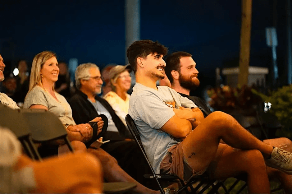 A group of friends and the audience laughing during a St Pete Standup comedy show