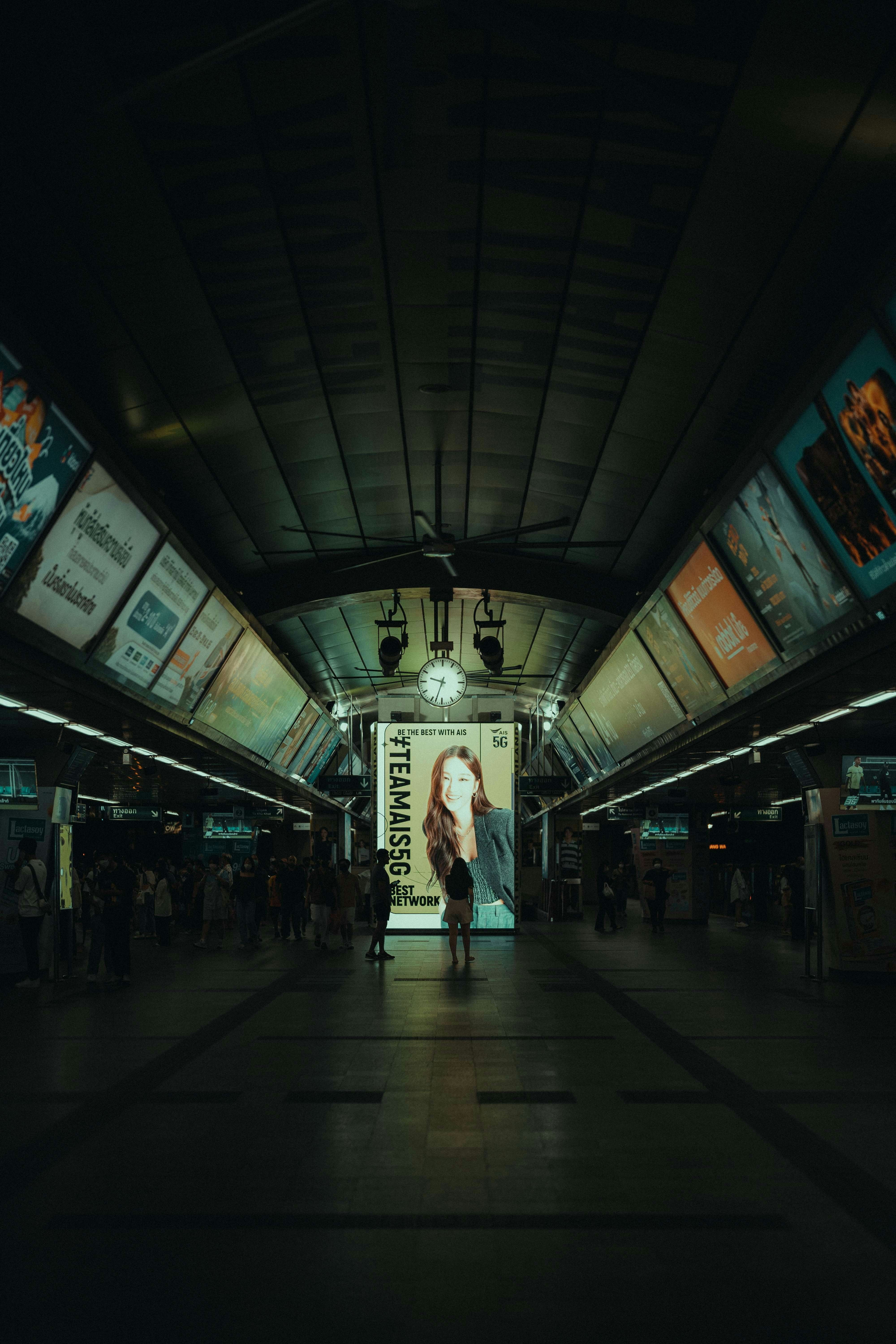 a woman is walking through a subway station