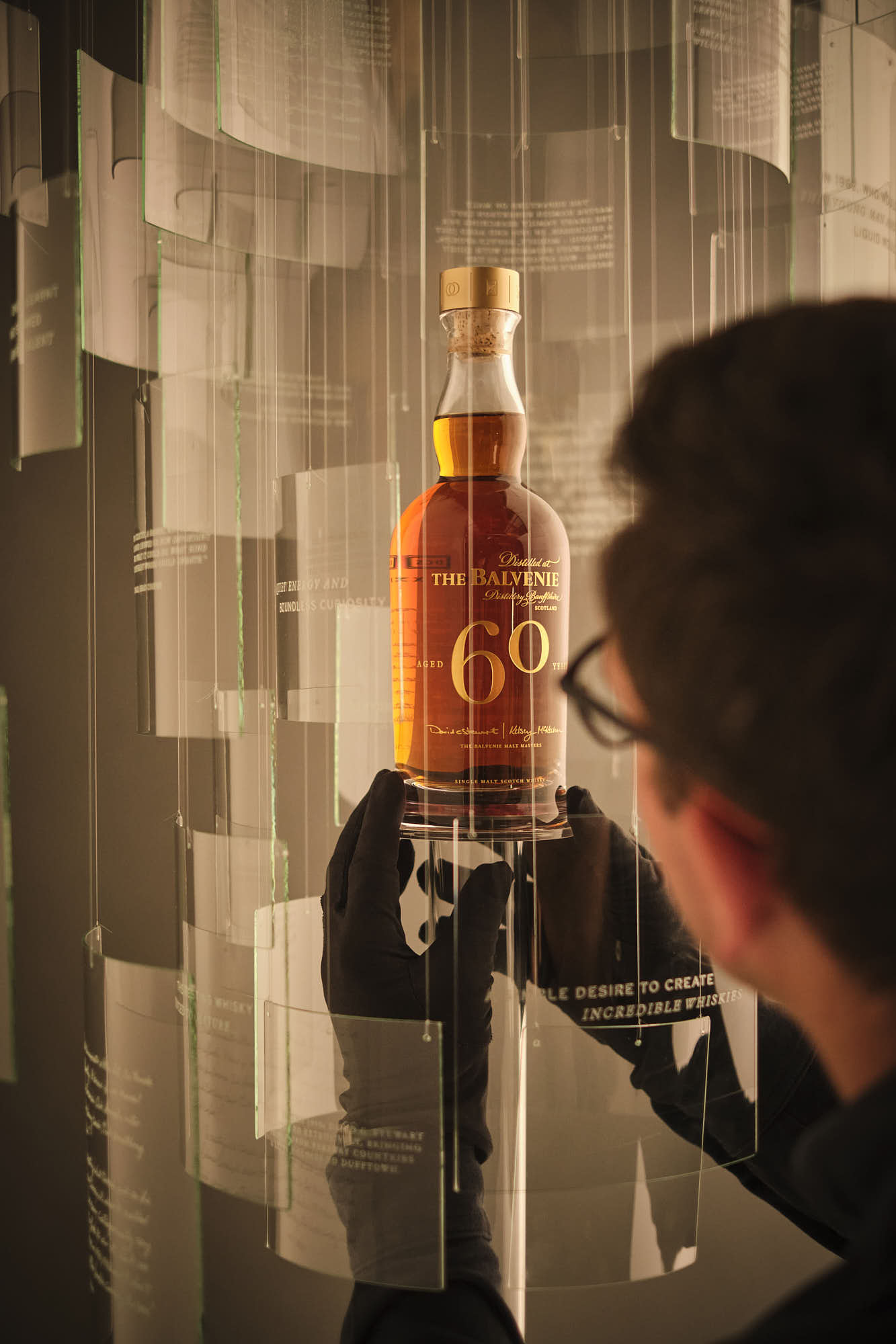 closeup of person styling the whiskey bottle in frame