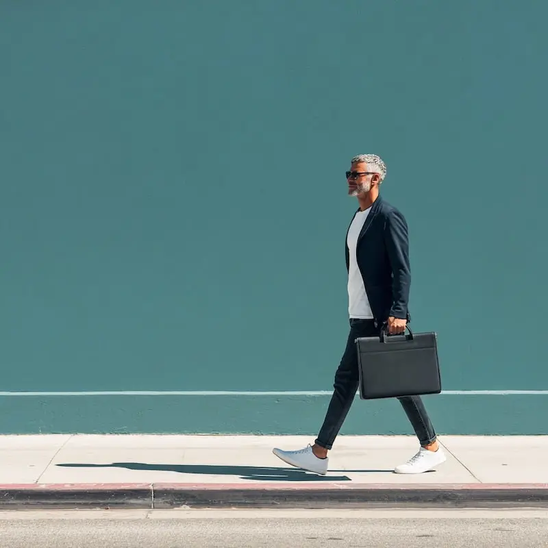 man in black long sleeve shirt sitting on chair beside woman in black and white stripe