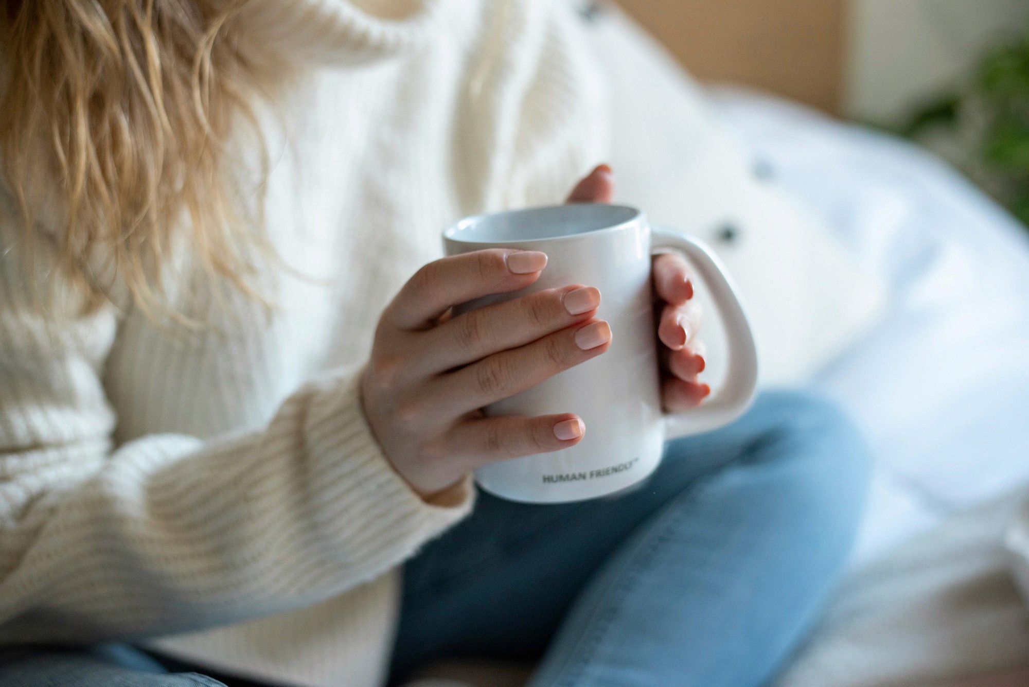 Close up of a mug of tea in a ladies hands