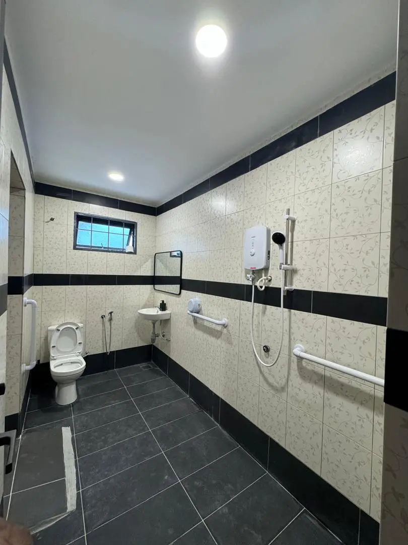 Clean and spacious first bathroom with safety features at Golden Oaks nursing home in Petaling Jaya.