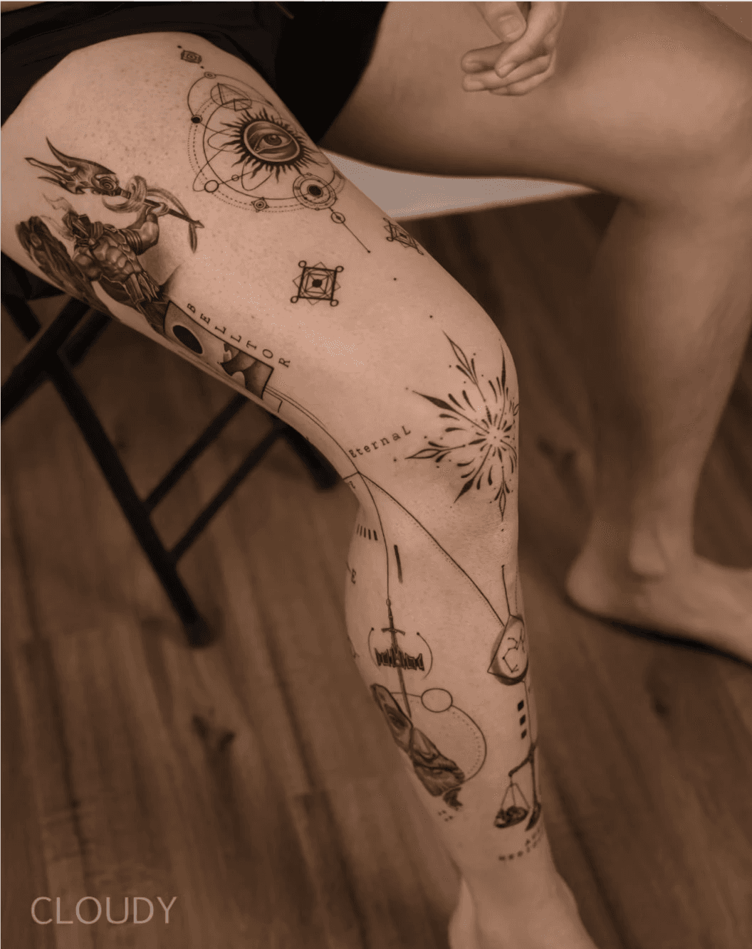 Leg tattoo with celestial and geometric patterns.