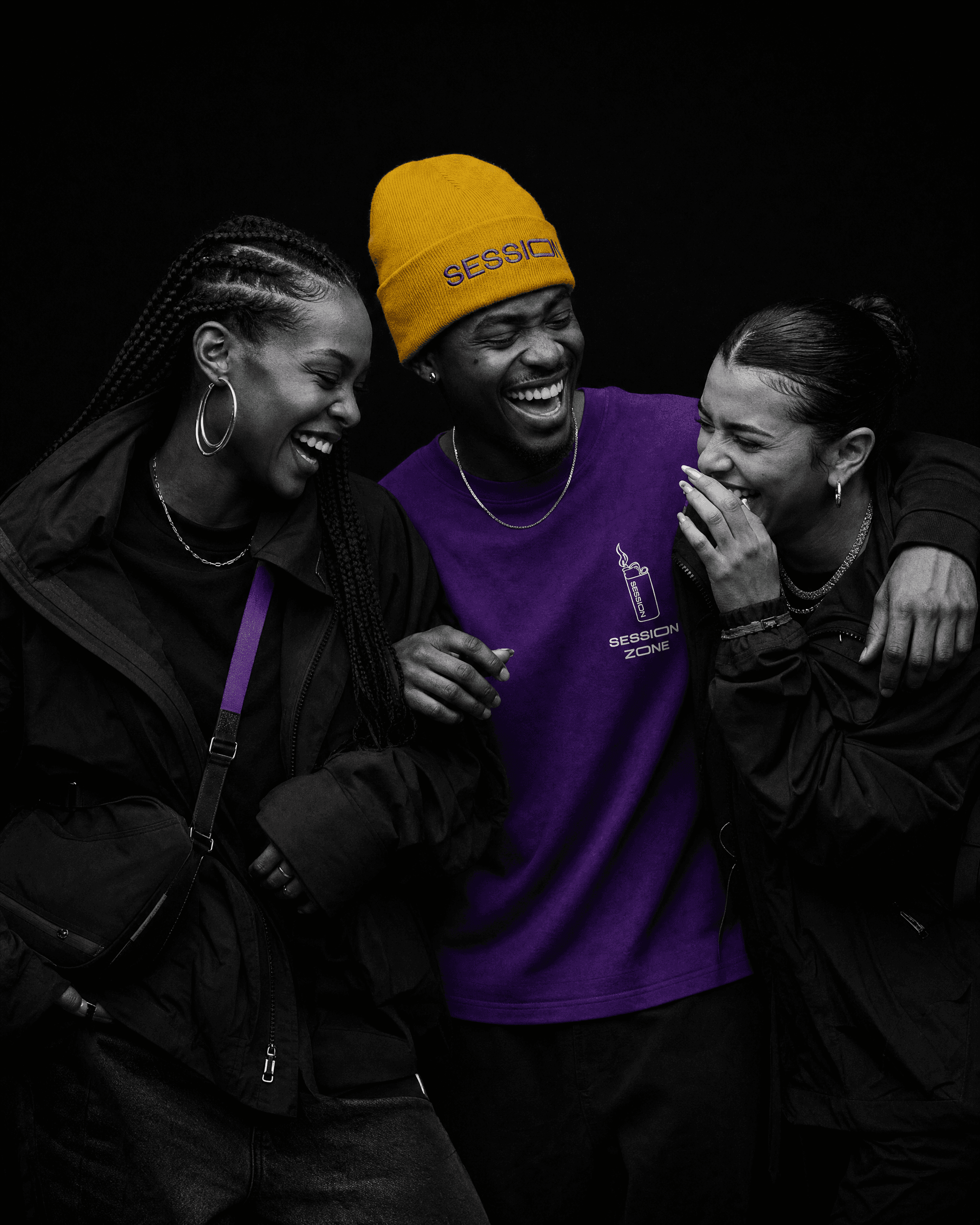 Three friends laughing, with the center person wearing a yellow Session Zone beanie and purple lighter-graphic T-shirt.