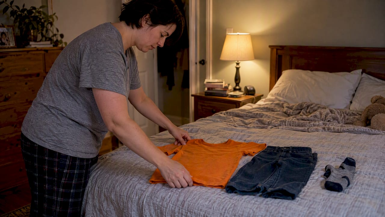 Caregiver lays out clothes for morning