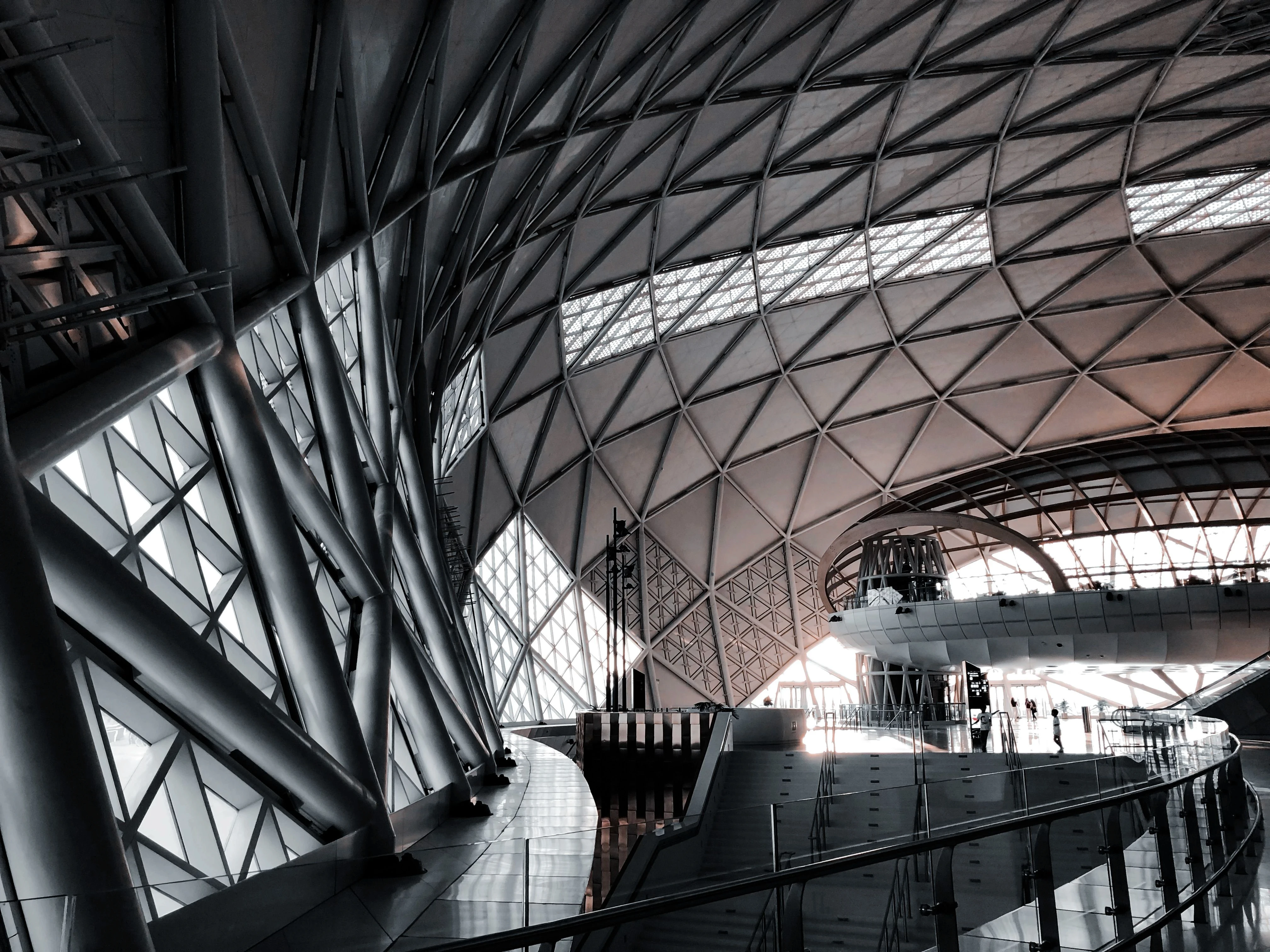 Modern ceiling architectural lattice design illuminated with bright geometric lights.
