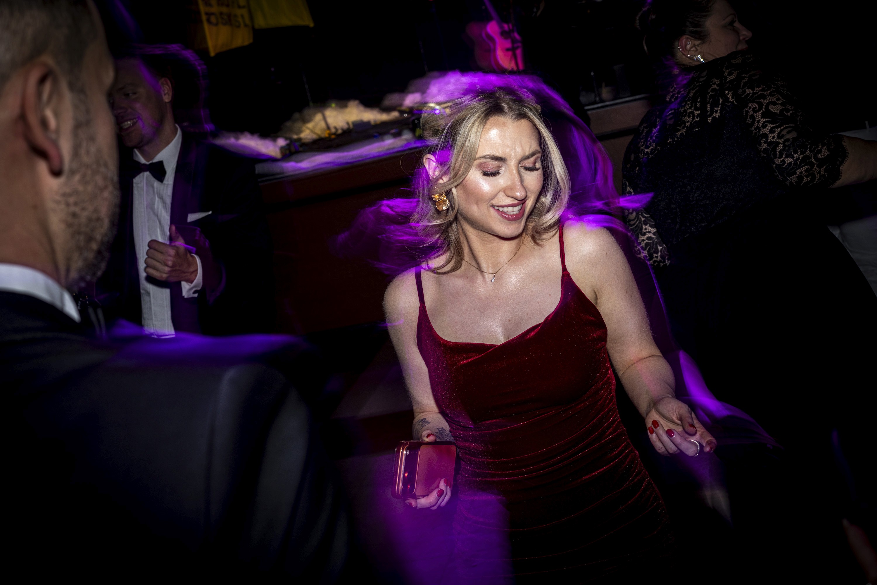 Brand representative presenting products at a sponsor booth during a business conference.