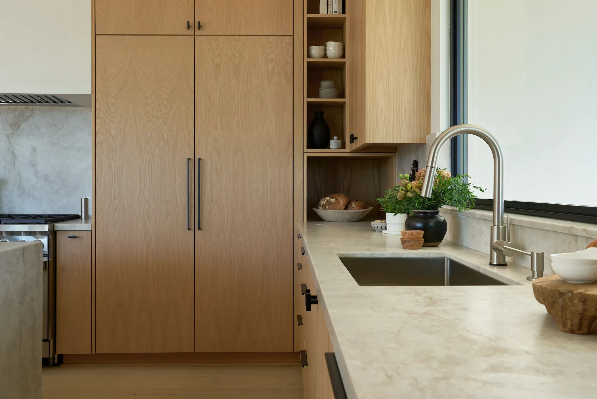 Detailed view of the modern faucet and sink in the Fullerton kitchen remodel. Photo by Todd Huge.