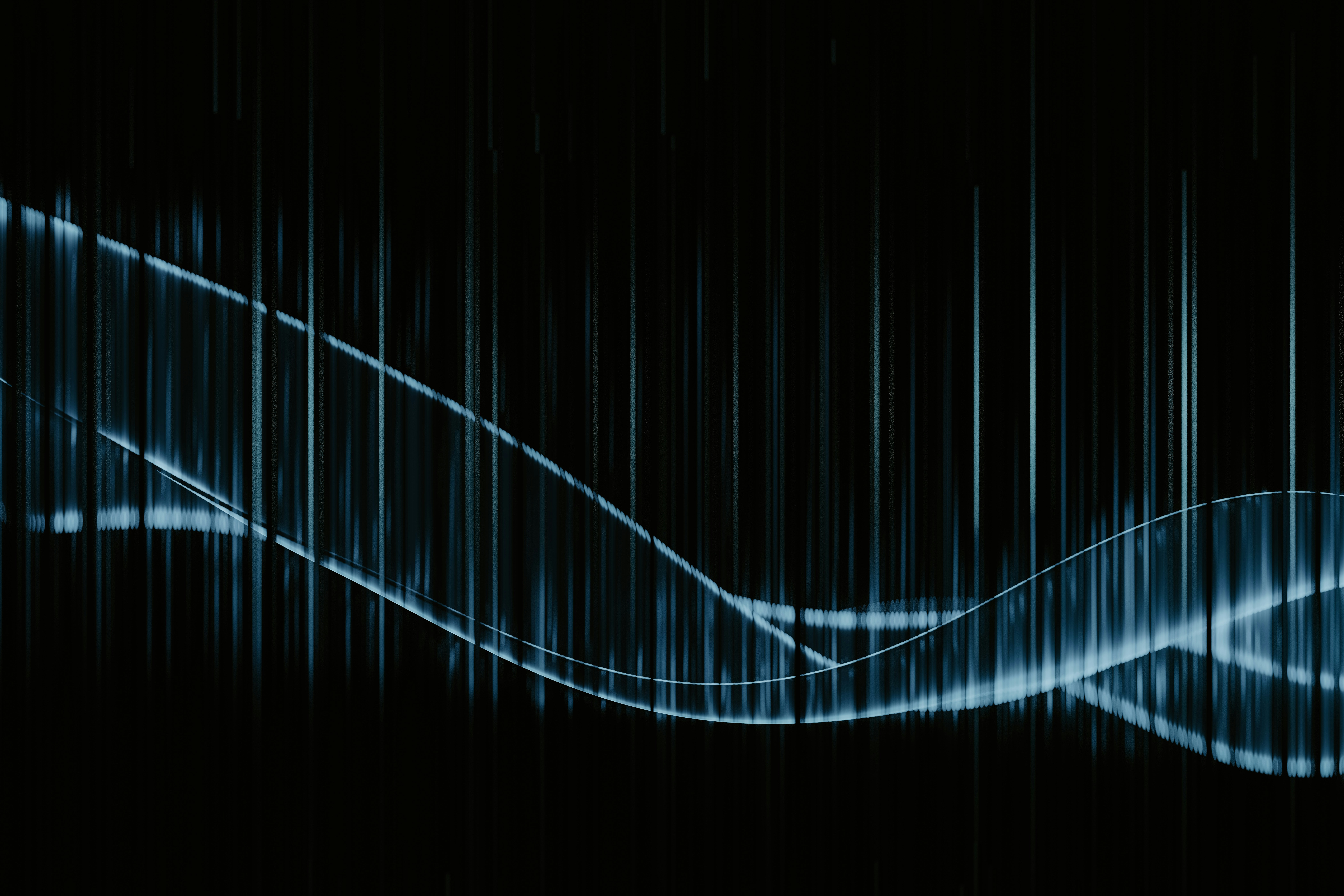 A black background with a blue wave on it