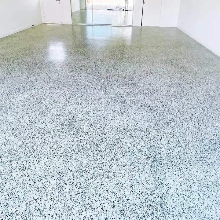 Decorative speckled floor coating in a bright residential room