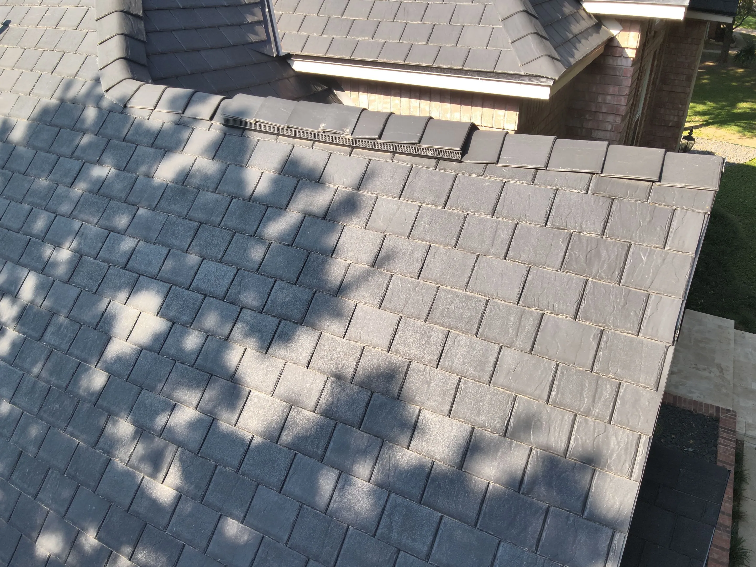 Shadow patterns on F-Wave synthetic shingles demonstrating dimensional appearance and quality installation in Corinth TX