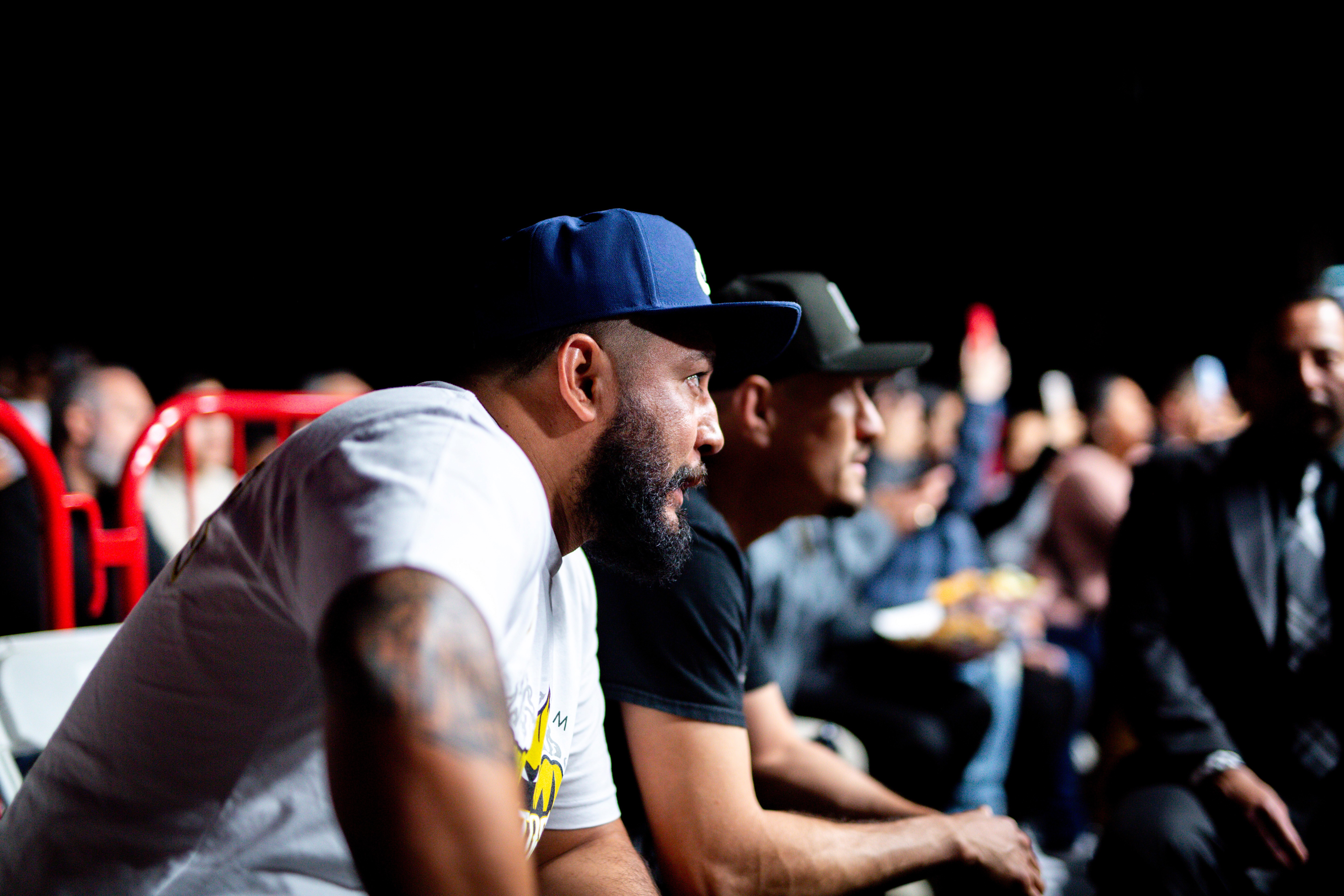 Jesús Soto Karass and Rene Ordorica watching George "El Phantasma" Navarro's fight from their seats while a California commisioner looks on.