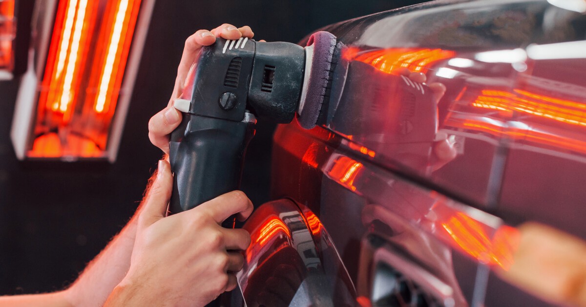 man wearing gray polo shirt beside dry-erase board