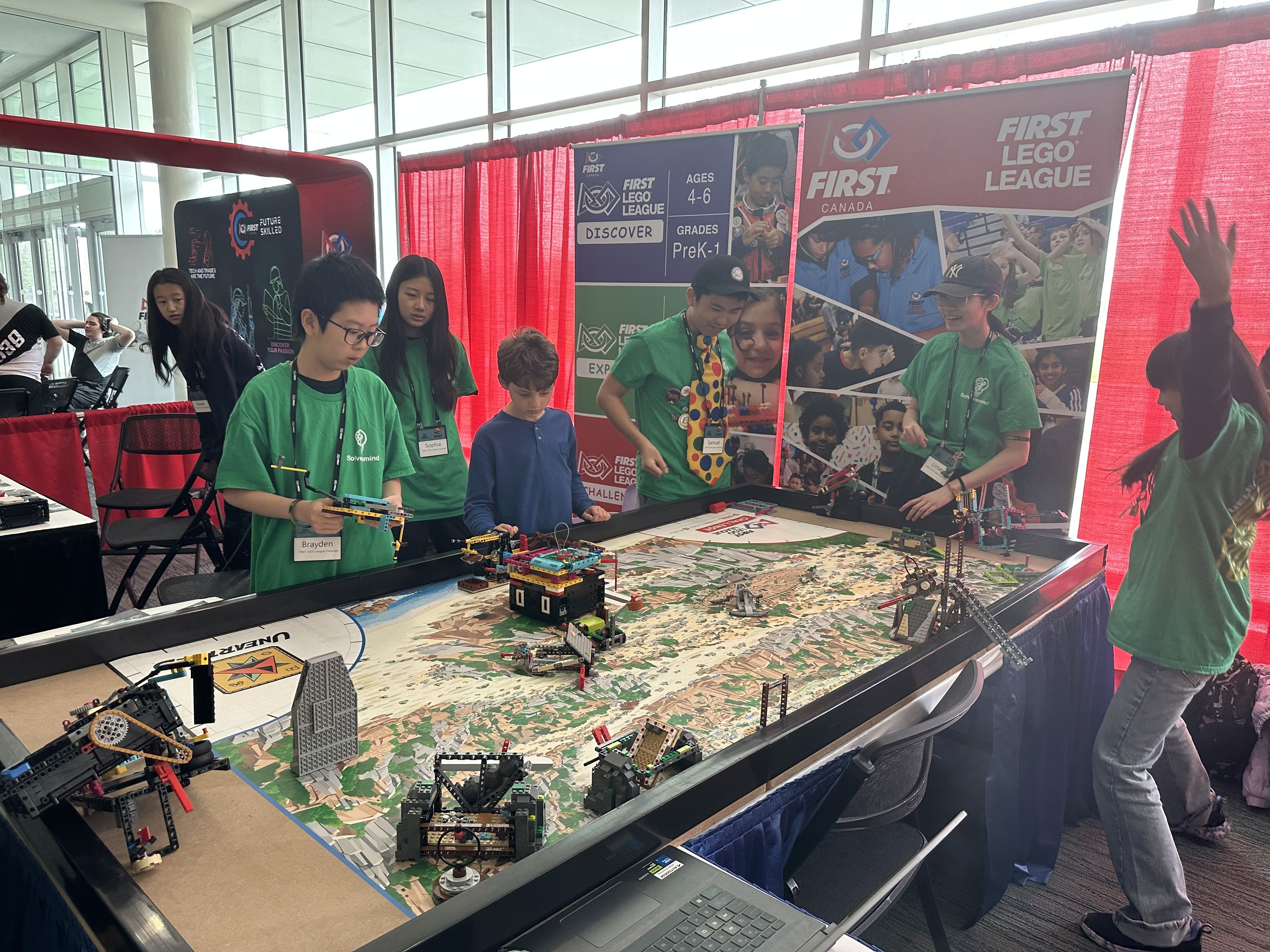 Chrono Solvers students demonstrating an autonomous FIRST LEGO League robot to families and professionals in Niagara Falls