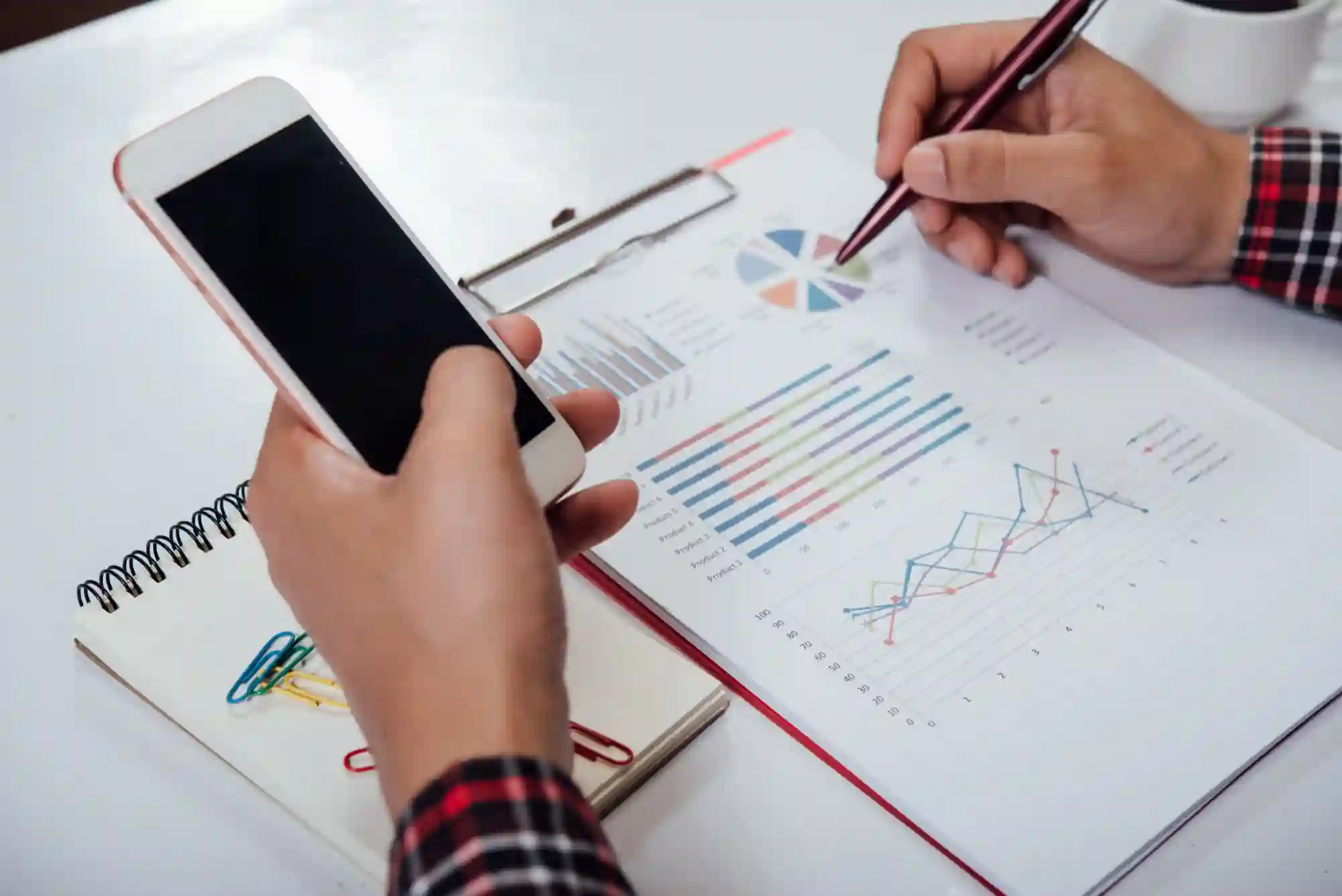 TikTok Shop creator analyzing video diagnosis feedback on a smartphone while reviewing a performance report.
