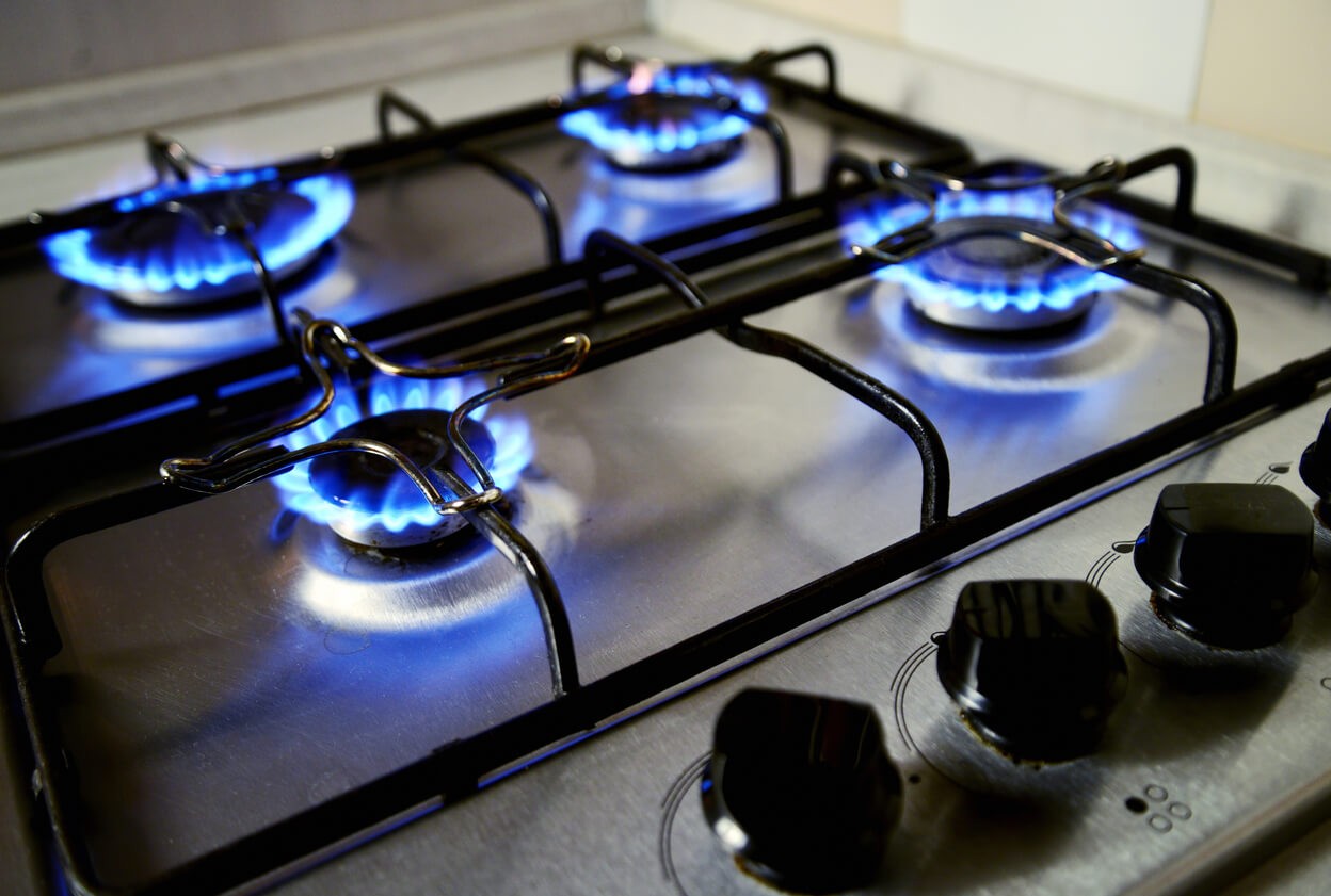 Gas stove with flames coming from the elements