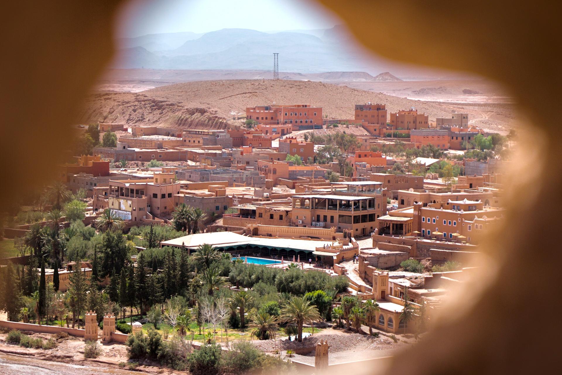 brown and white temple surrounded by green trees during daytime