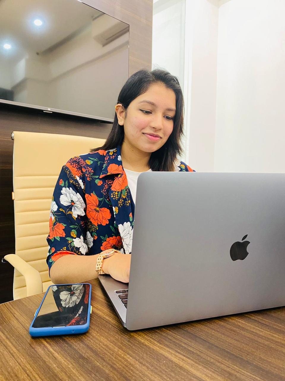 Mountain peak reflecting in calm lake at sunrise.