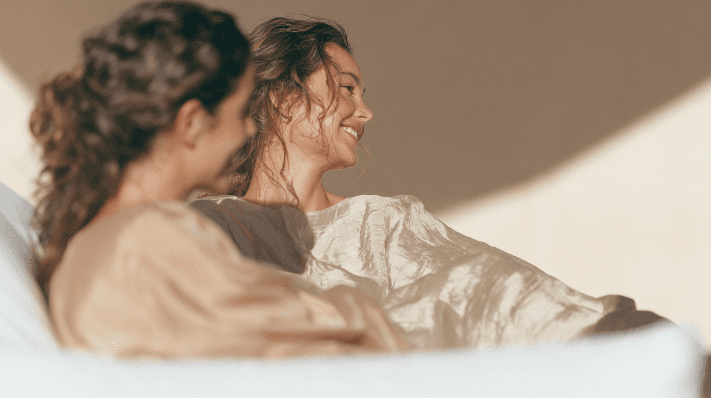Two women embracing in soft natural light, reflecting the calm, unhurried care at the heart of Plaza Wellness.