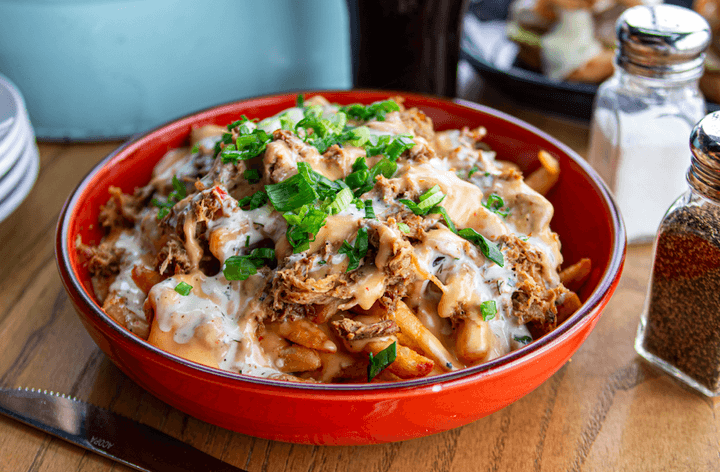 Iowan fries with Pulled Pork, House Ranch, Queso, Scallion