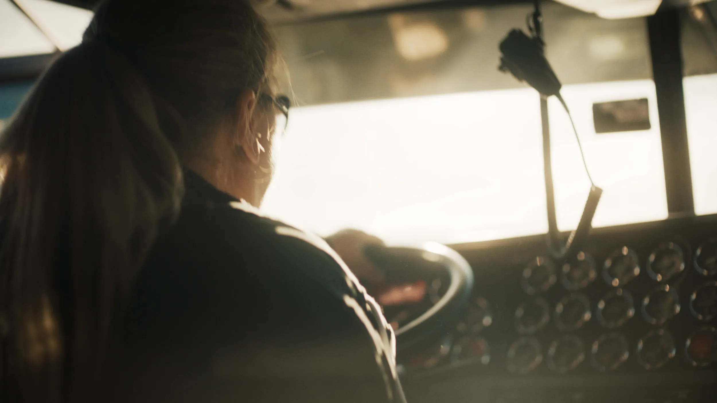 A driver sitting at the wheel of a large truck.
