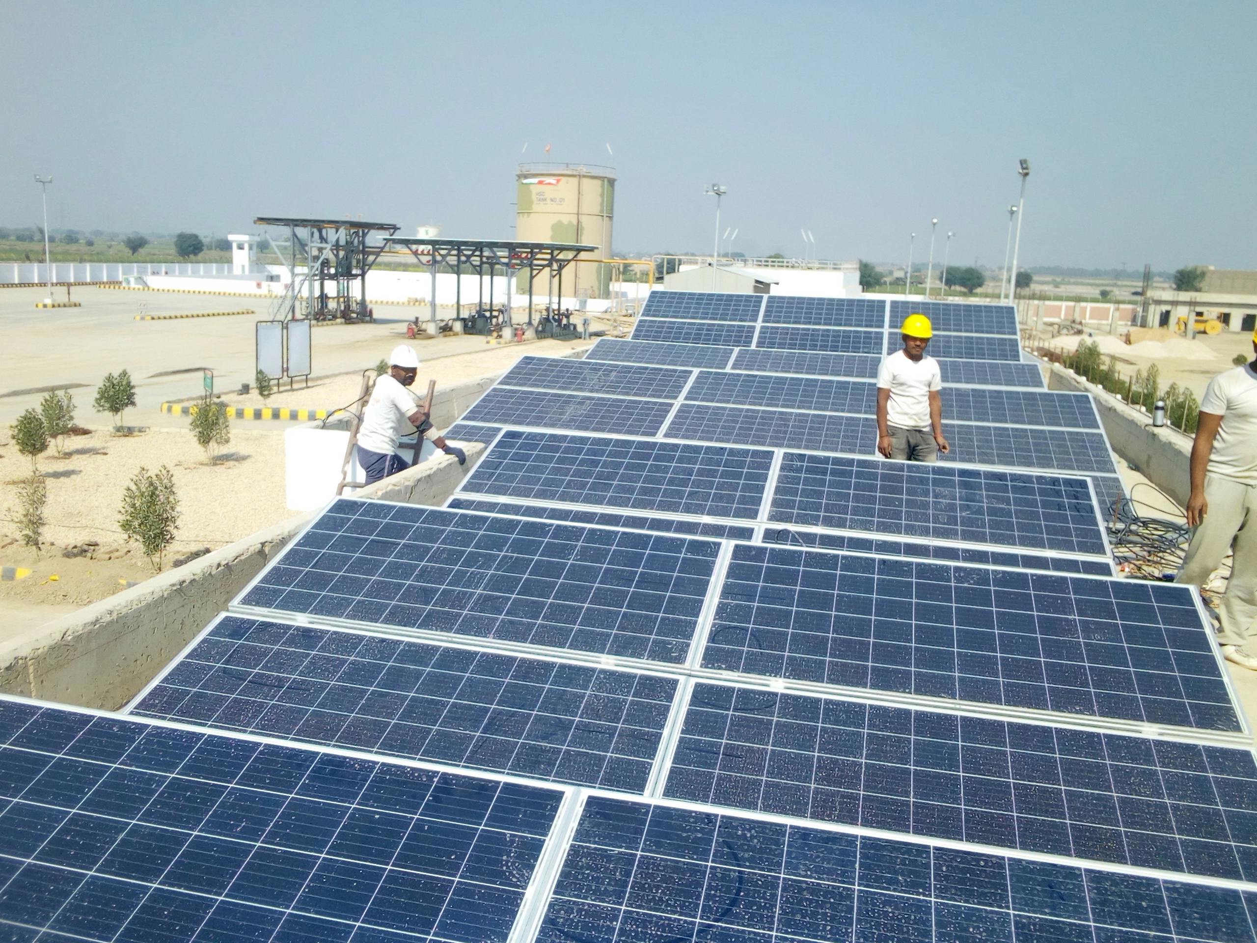 people intalling solar panel at a rooftop