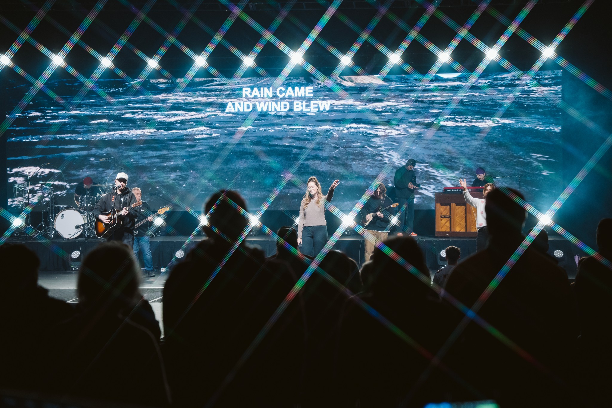 two people in a workspace working on their laptops 