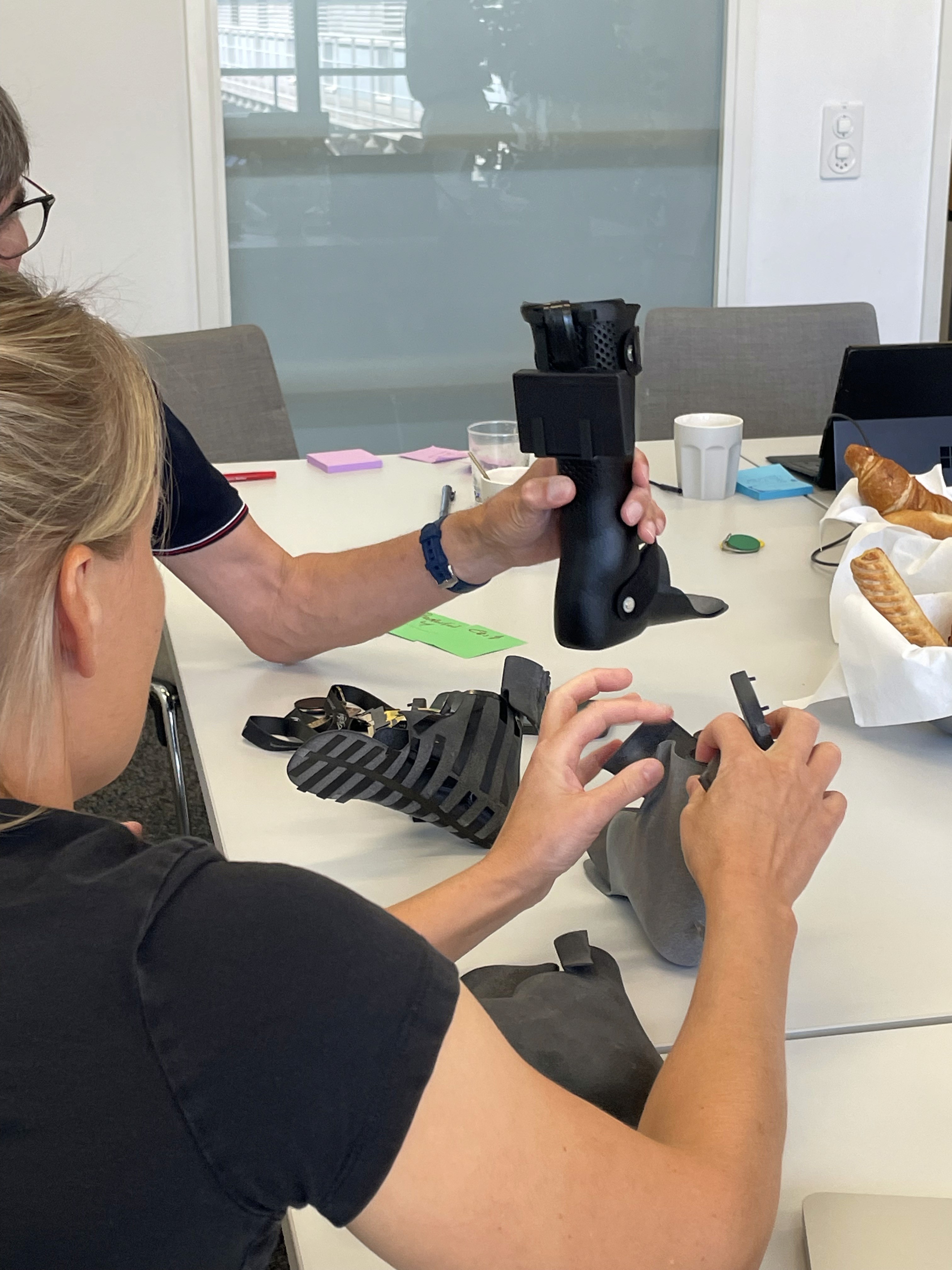 two people in a workspace working on their laptops 